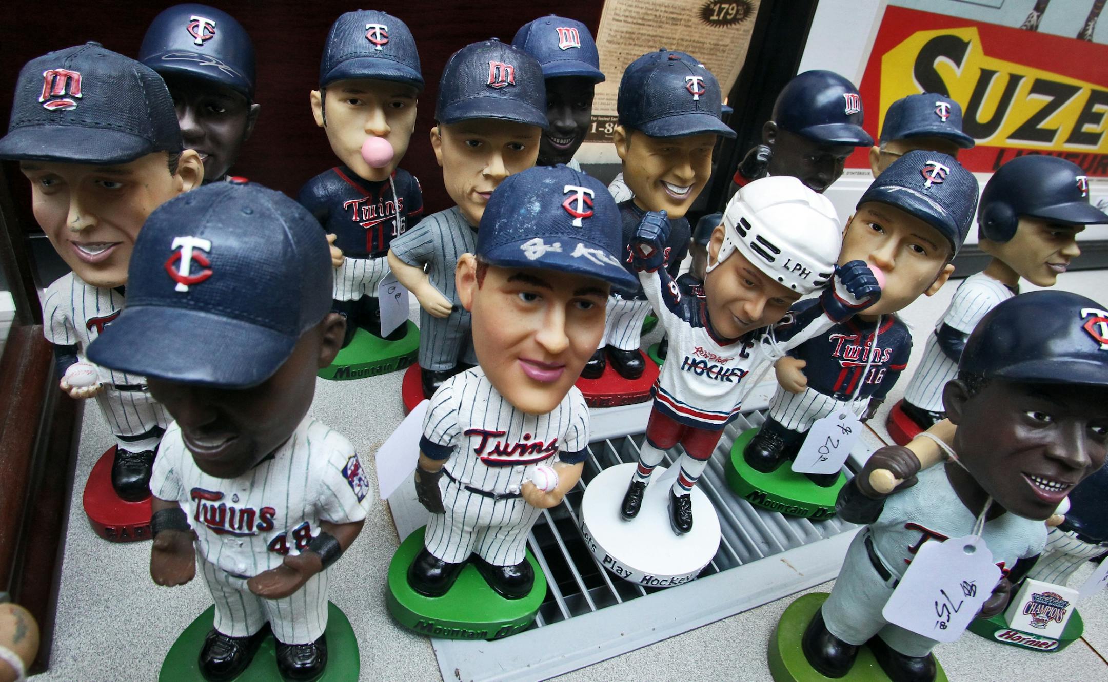 The eclectic belongings of the late Dark Star soon to be sold at a local estate sale. Pictured: Twins bobble-head dolls.