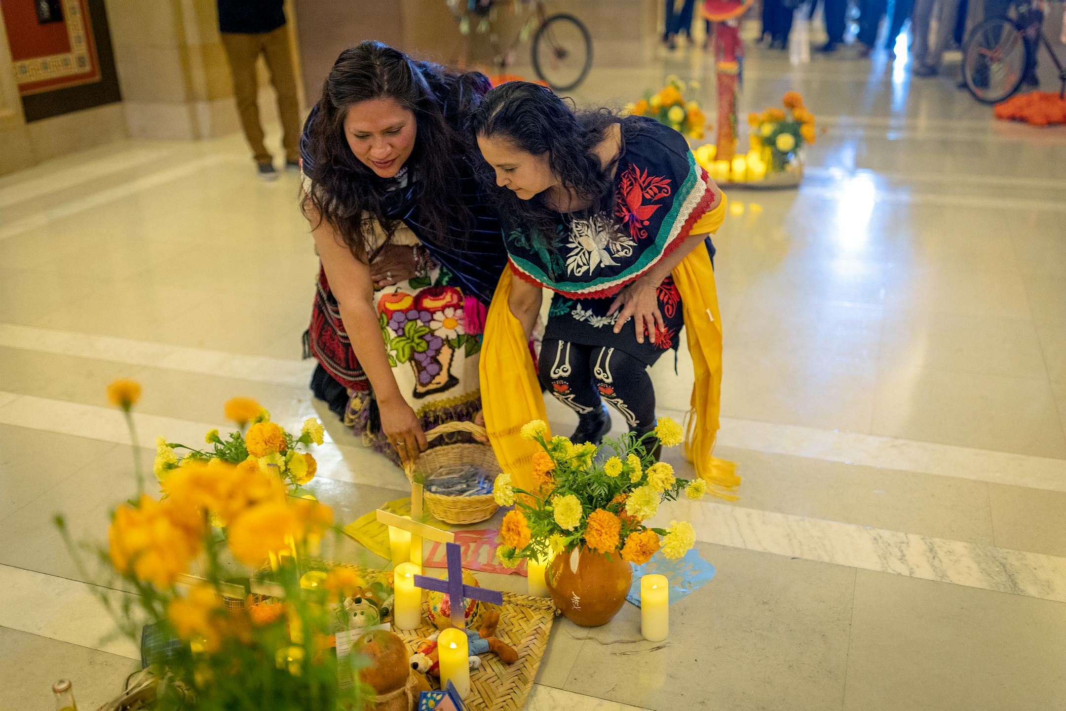 Minnesota artists Monica Vega, left, and Flor Soto, welcome the community to visit the first ever "Altar de Muertos" or community altar for Days of the Dead at the Minnesota State Capitol.