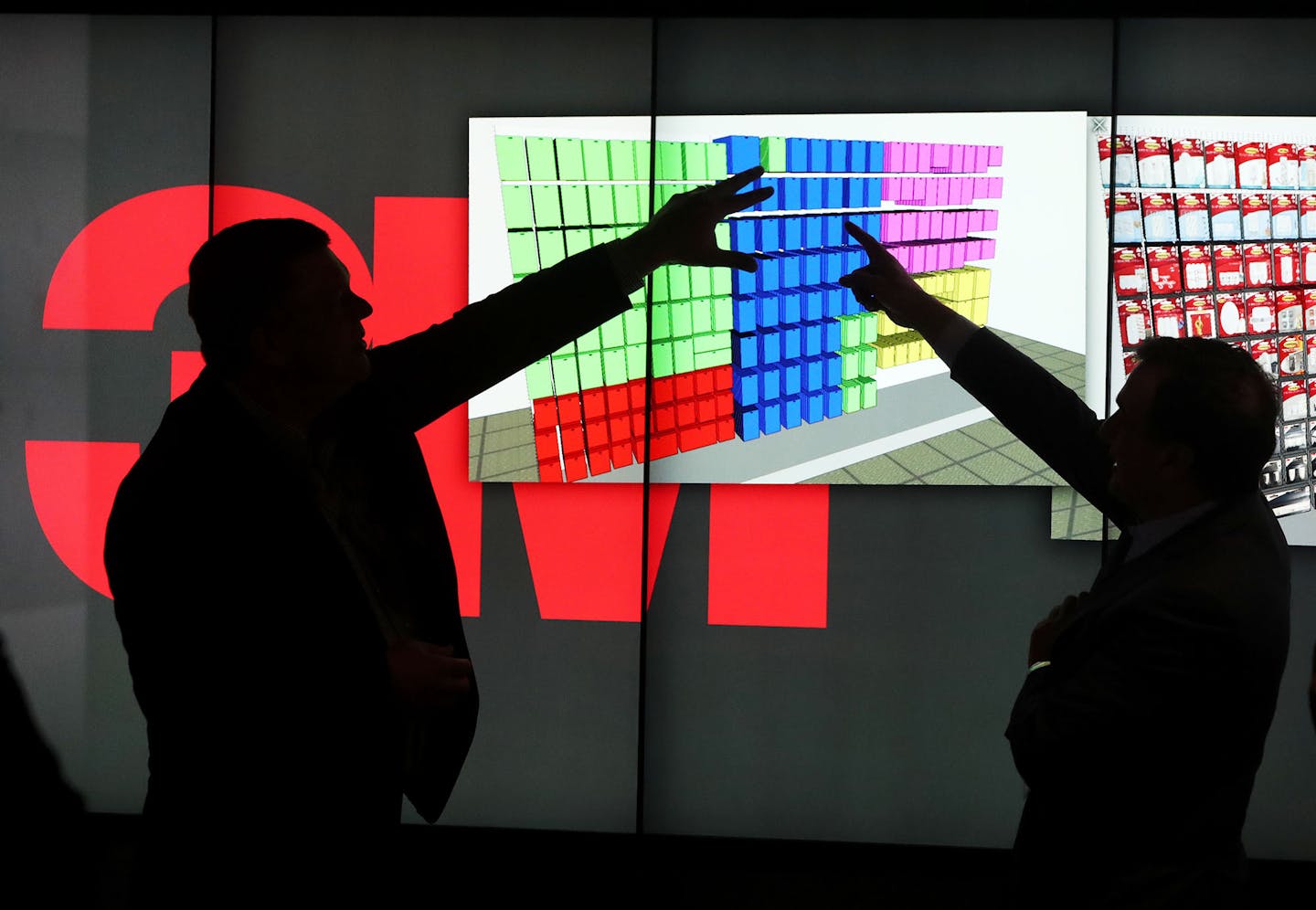 Todd Braunlich, 3M's global retail analytics director, left, and Joaquin Delgado, executive vice president of the consumer business, show features of 3M's new consumer data-science lab at the Maplewood campus. (DAVID JOLES&#x2022;david.joles@startribune.com)