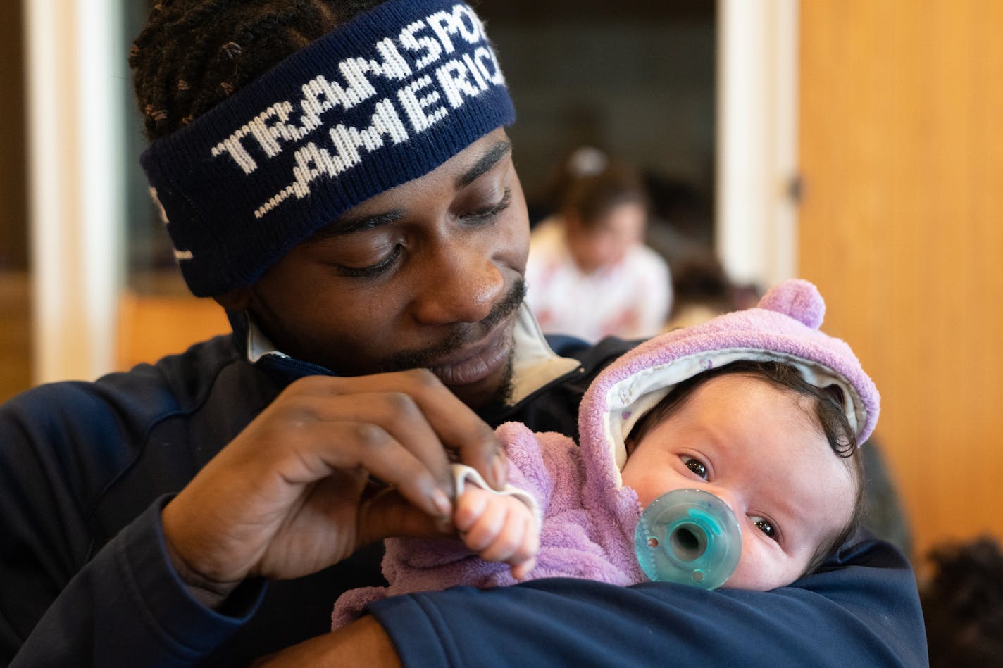 Jamal Jones cradled his five-week-old daughter Chanel in a common room at Bethlehem Baptist Church. ] MARK VANCLEAVE &#xa5; Jamal Jones and Alliyah Ross (both 20) and their five-week-old daughter Chanel have been staying at Bethlehem Baptist Church with about 100 other former Francis Drake Hotel residents since the Christmas Day fire. Photographed Friday, Dec. 27, 2019 in Minneapolis.