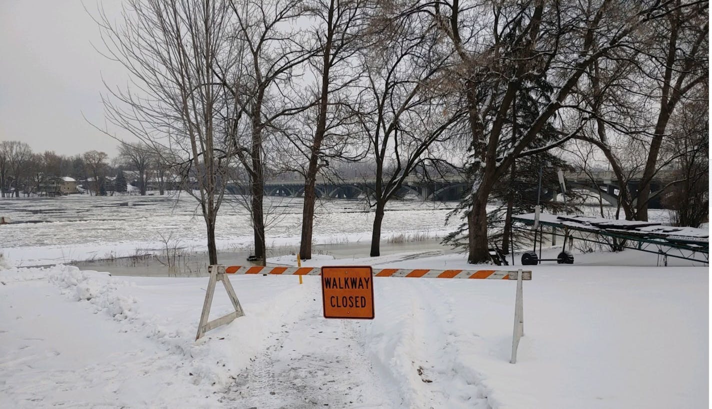 A walkway along the Mississippi River was closed Monday because of high water.