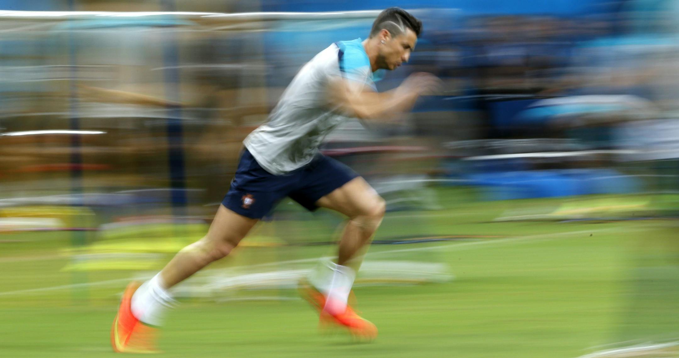 In this photograph taken with a slow shutter, Portugal's Cristiano Ronaldo works out during a training session at the Arena da Amazonia in Manaus, Brazil, Sunday, June 22, 2014. Portugal will play against the United States in group G of the 2014 soccer World Cup on June 22. (AP Photo/Julio Cortez)