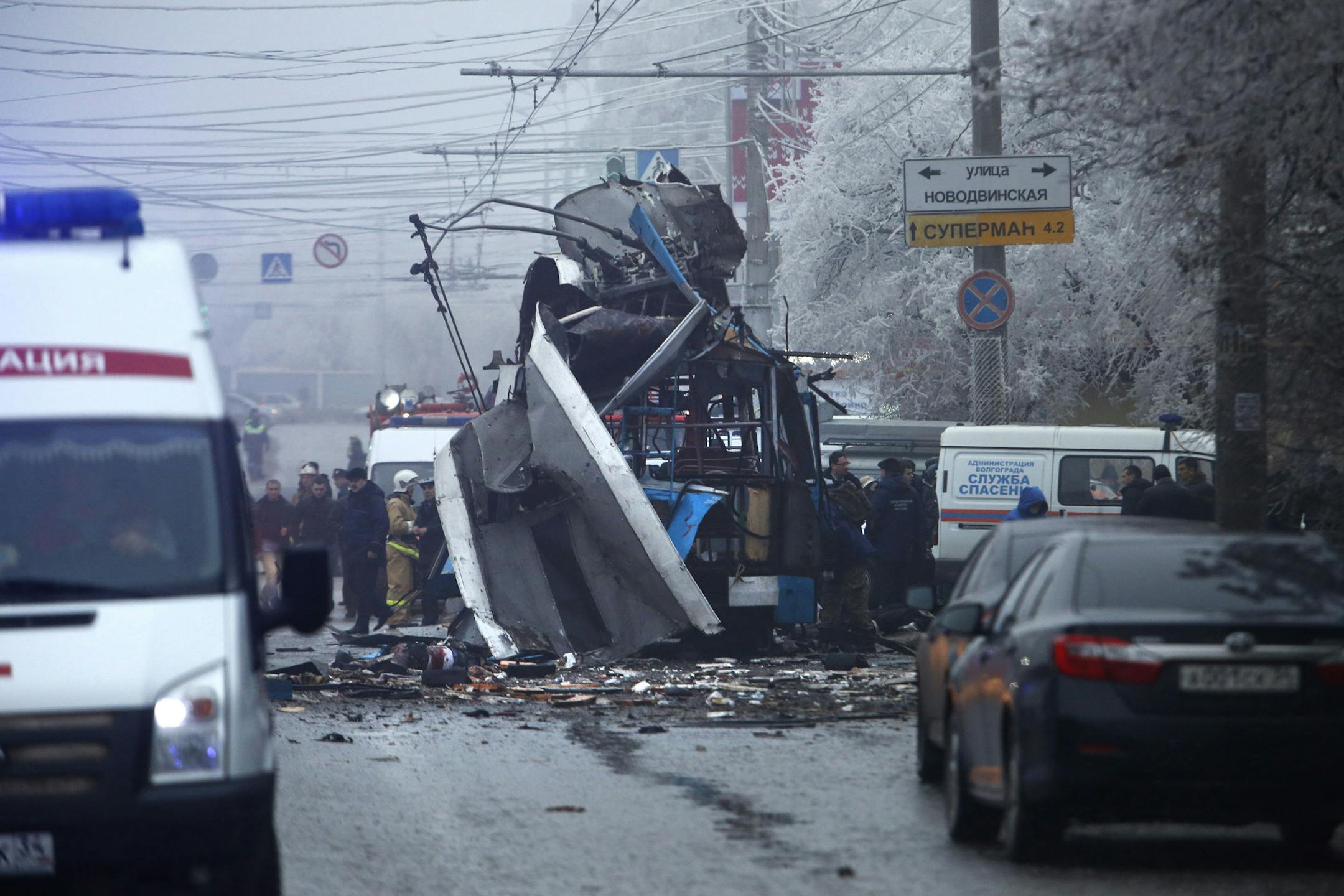 Experts and police officers examine a site of a trolleybus explosion in Volgograd, Russia Monday, Dec. 30, 2013. A bomb blast tore through the trolleybus in the city of Volgograd on Monday morning, killing at least 10 people a day after a suicide bombing that killed at 17 at the cityís main railway station. (AP Photo/Denis Tyrin)