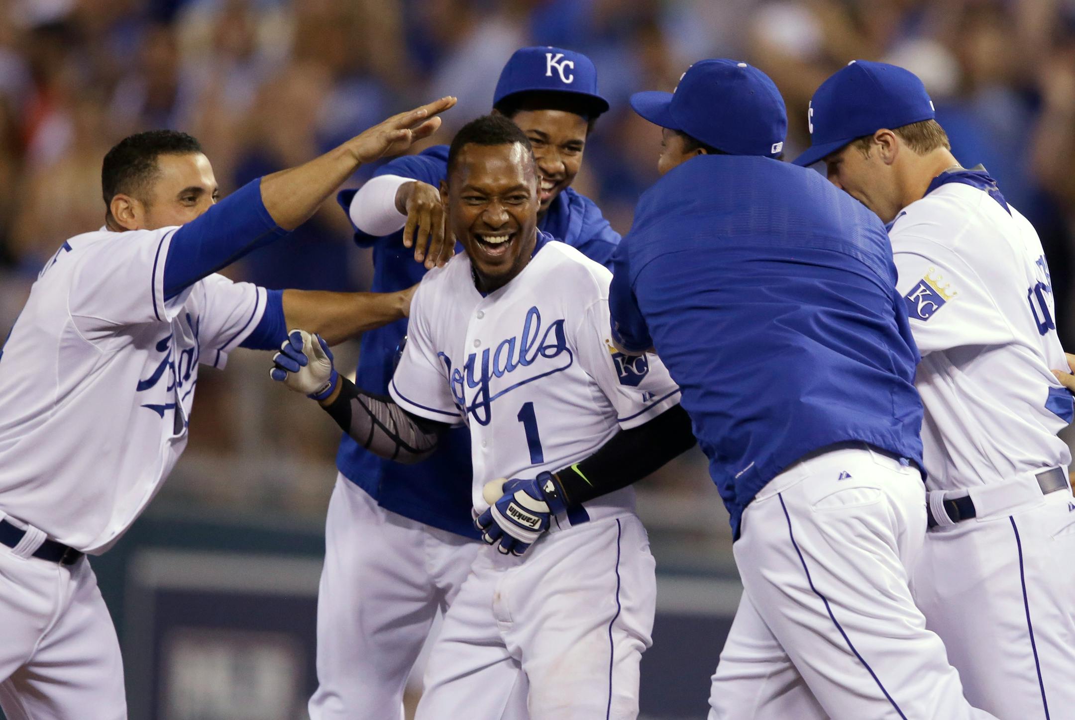 Kansas City Royals' Jarrod Dyson (1) is mobbed by teammates after driving in the winning run during the 10th inning of a baseball game against the Minnesota Twins at Kauffman Stadium in Kansas City, Mo., Friday, July 3, 2015. The Royals defeated the Twins 3-2. (AP Photo/Orlin Wagner)