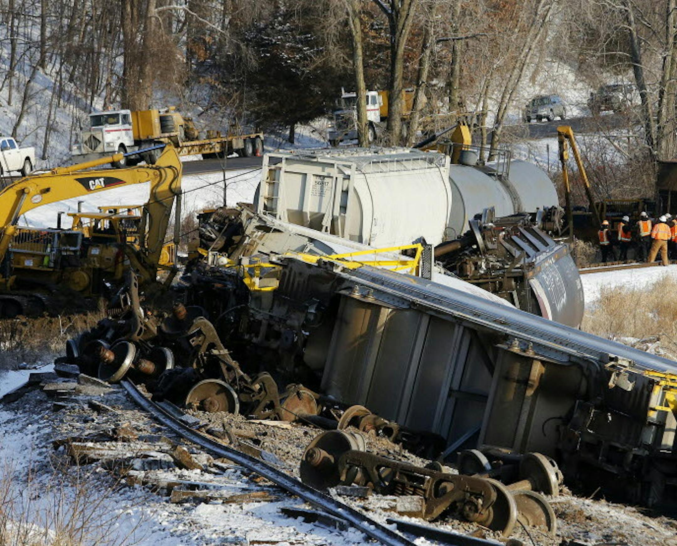 Crews work the scene of a train derailment Wednesday, Jan. 27, 2016, along Hwy. 26 south of Brownsville, Minn. Authorities say two of six derailed train cars have broken through the ice on the Mississippi River in southeastern Minnesota. (Andrew Link/The Rochester Post-Bulletin via AP) MANDATORY CREDIT TRAIN DERAILMENT MISSISSIPPI RIVER