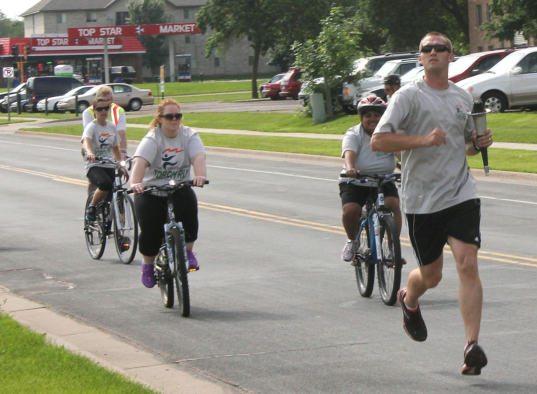 Runners and bicyclists participate in the 2013 Torch Run, which benefits Special Olympics. This year, the Police Department is opening up the event for public participation.‚Äã City of Shakopee