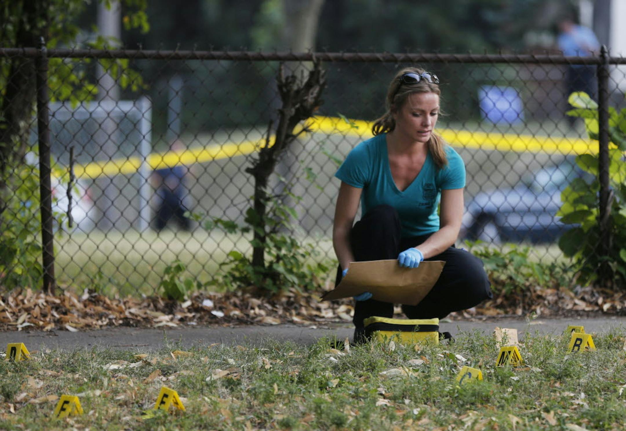Police crime lab personnel investigated the area on Lyndale Ave North between 29th and 30th where three people were shot Tuesday evening.