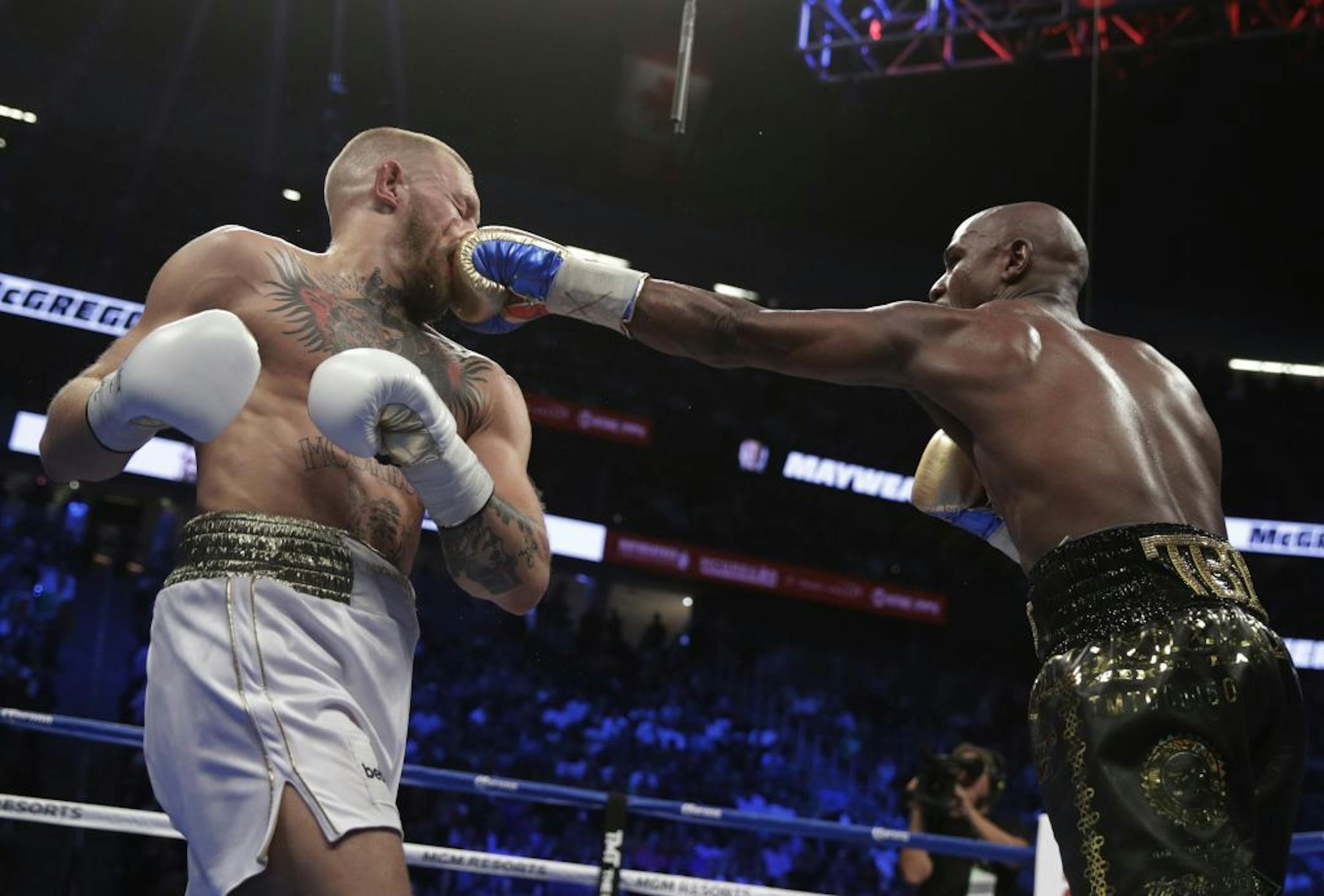 Floyd Mayweather Jr. jabs Conor McGregor in a super welterweight boxing match Saturday, Aug. 26, 2017, in Las Vegas.