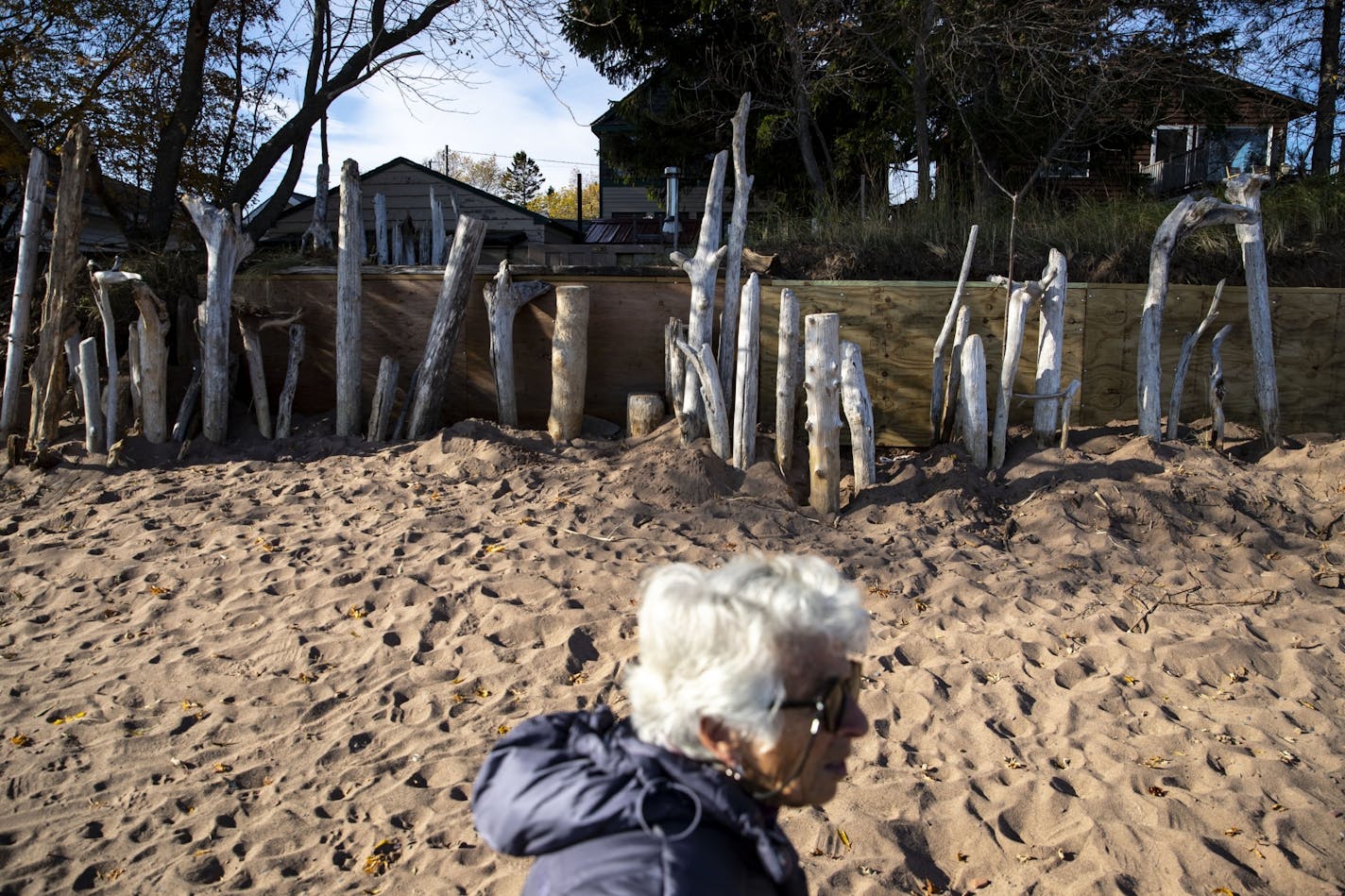 Jan Karon walked along Park Point beach showing how all of her neighbors have attempted to deal with the erosion and large waves from Lake Superior.