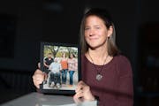 Katie Wheeler held a photograph of her late husband, Steve, and their daughters Meskele, 16, left, and Shibere, 18, right. Wheeler’s husband died in