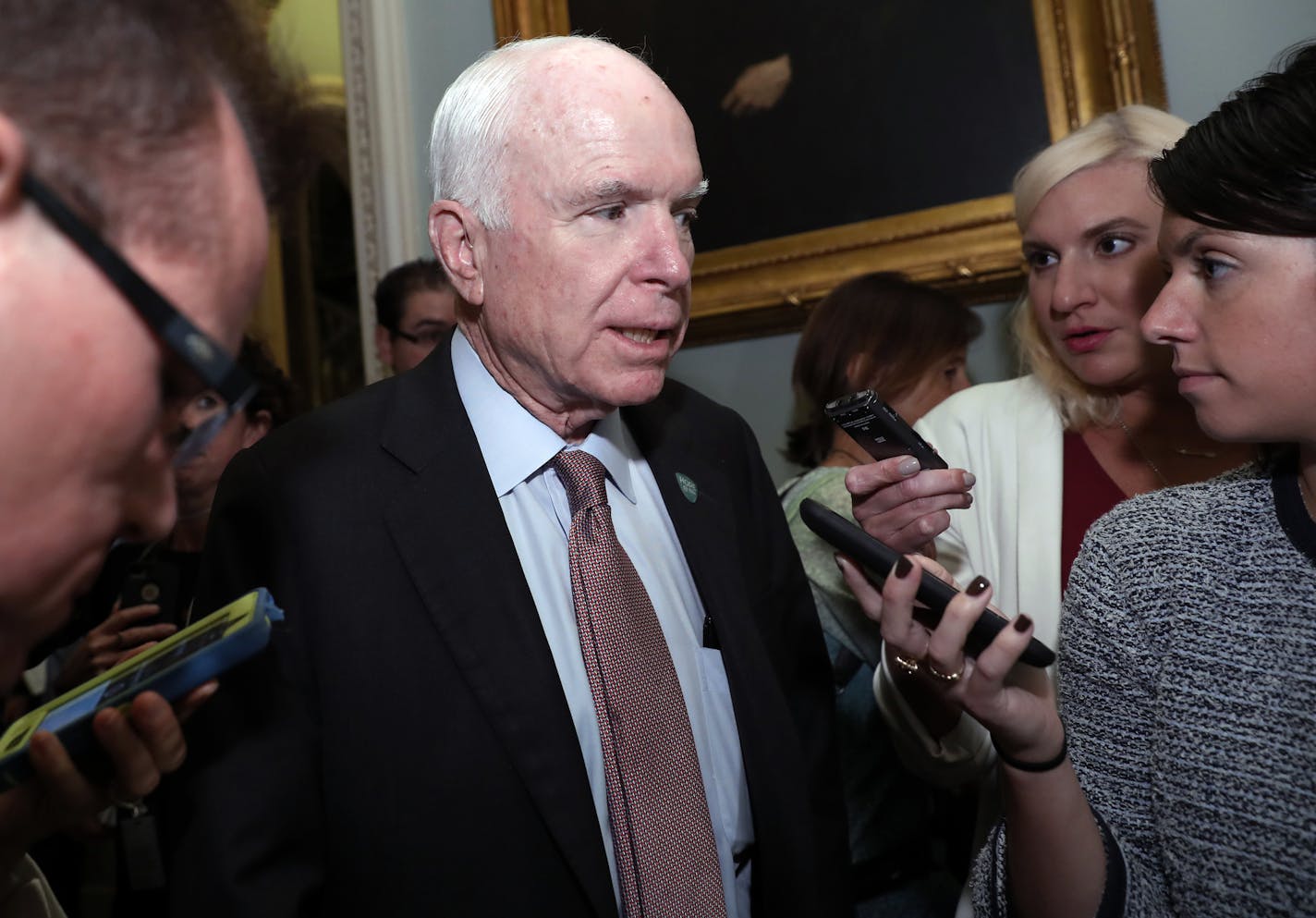 Sen. John McCain, R-Ariz., speaks with reporters before heading into a policy luncheon on Capitol Hill, Tuesday, Sept. 19, 2017, in Washington.