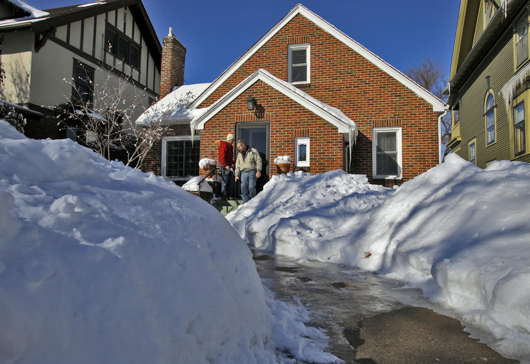 Marcy Wengler is a real estate agent in St. Paul who has found difficulty selling houses this winter due to the harsh weather conditions. She has responded by making cookies and coffee for those that endure the snow and cold to tour her sale homes. Snow was piled up around a St. Paul home that was the subject of a recent Wengler's open house. (MARLIN LEVISON/STARTRIBUNE(mlevison@startribune.com)