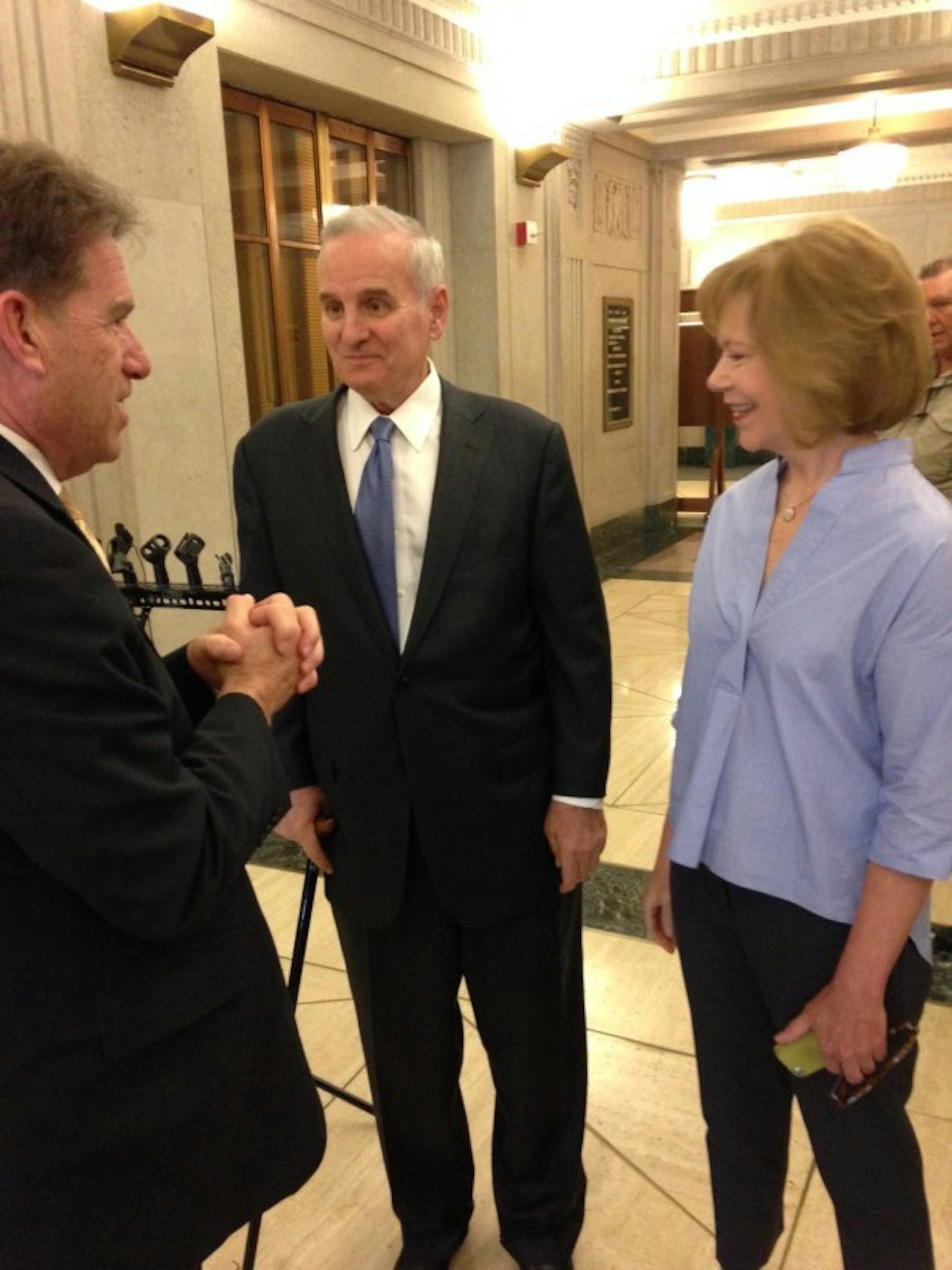 Mark Dayton, center, and Tina Smith talk with Secretary of State Mark Ritchie