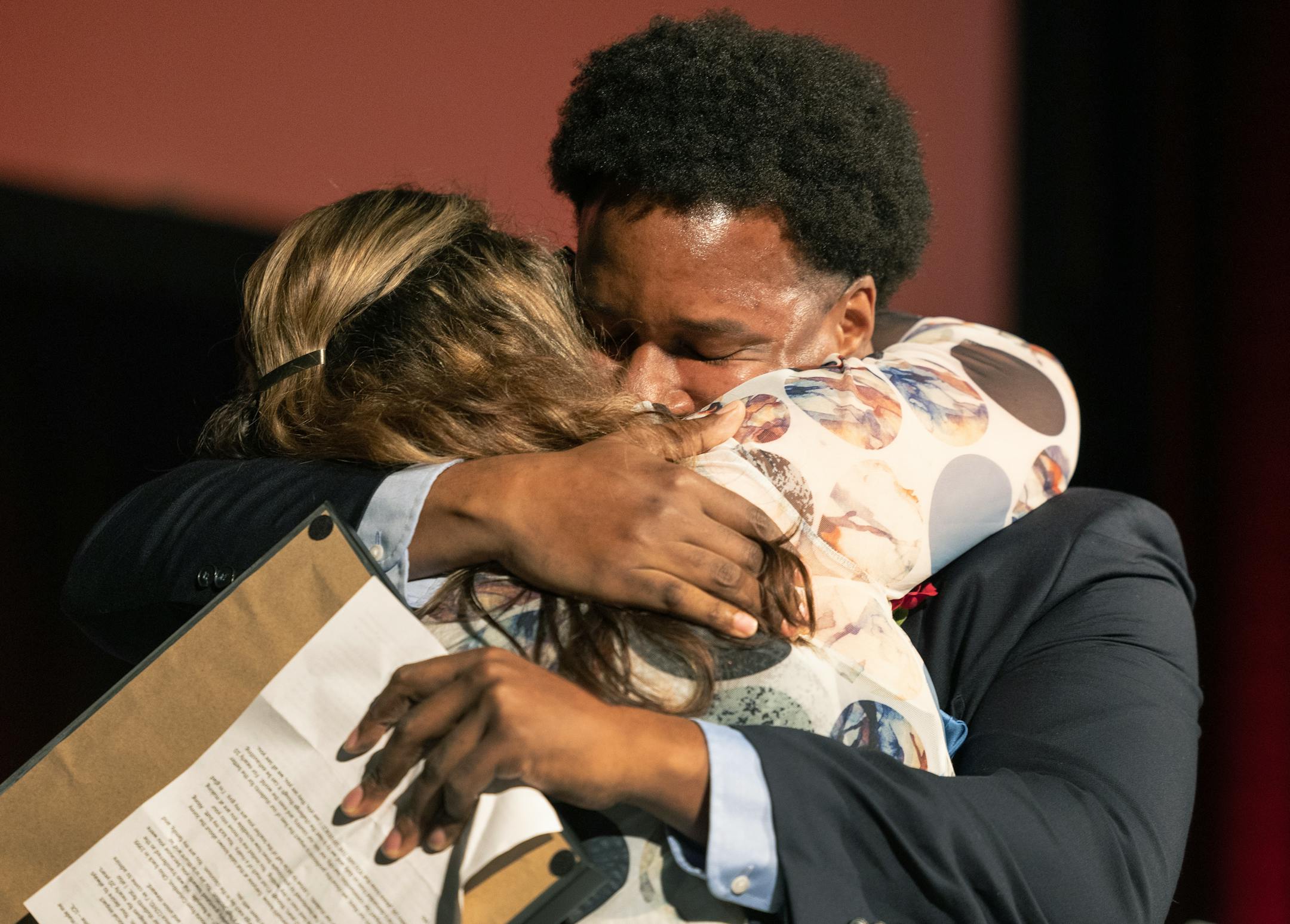 Teacher of the Year finalist Molly Megan Keenan hugs Michael Houston, a mathematics teacher at Harding High School in St. Paul Public Schools, after his acceptance speech.