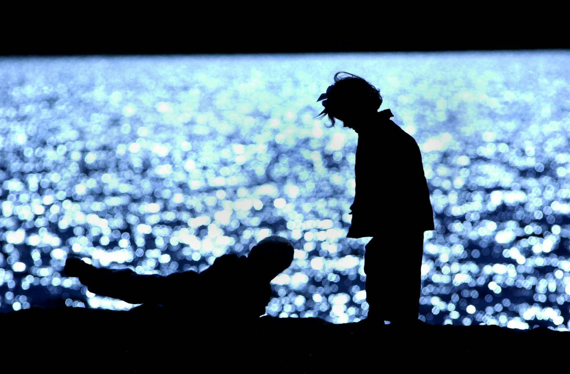 L to R 4 yr old Mac Turner of Minneaplis and 3 yr old Georgia Johnson of Orono frolic on the beach in Wayzata ,Mn. on Lake Minnetonka