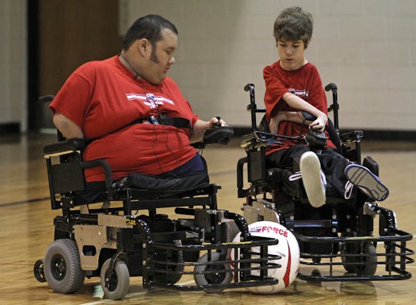 (left) Peter Winslow passed the soccer ball during practice at the King of Grace Church gym on 10/22/11. Winslow is a local paraplegic soccer player w