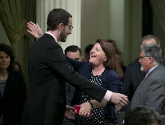 State Sen. Toni Atkins, D-San Diego, receives congratulations from Sen. Scott Wiener, D-San Francisco, after her housing measure was approved by the s