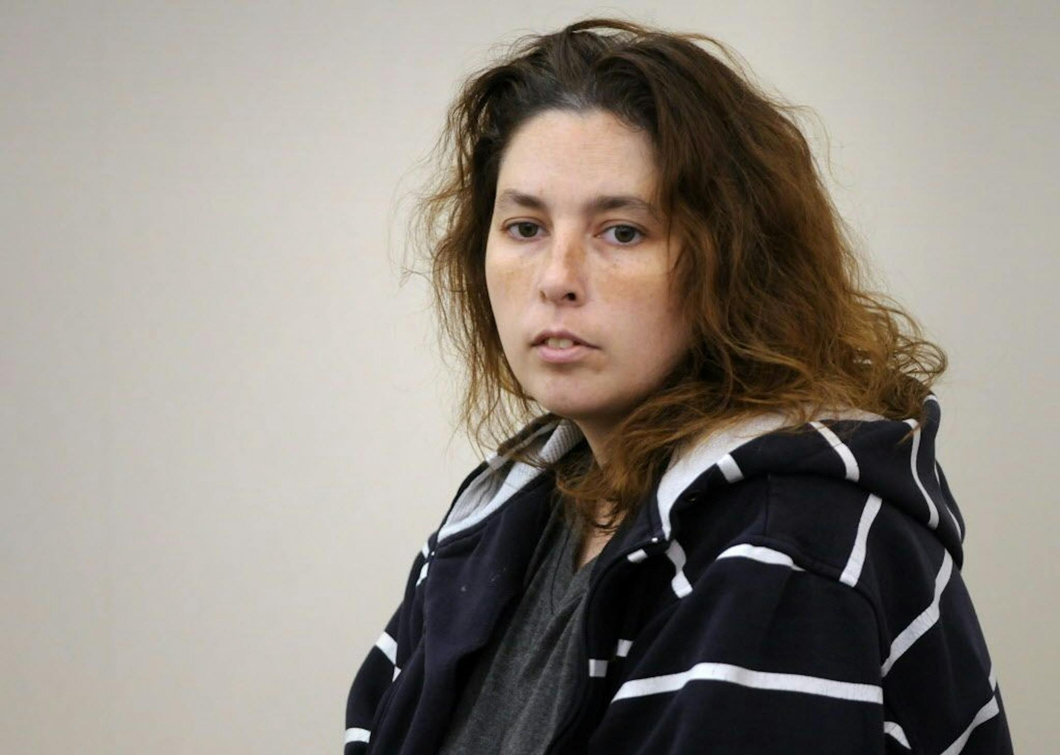 Erika Murray enters the courtroom by a court officer for her arraignment at Uxbridge District Court in Uxbridge, Mass. on Friday, Sept. 12, 2014.