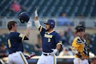 Michigan left fielder Cody Bruder (3) was congratulated by teammate Michigan third baseman Travis Maezes (9) after he homered in the second inning Thu