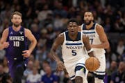 Timberwolves guard Anthony Edwards (5) started a fast break as teammate Rudy Gobert, right, and Kings forward Domantas Sabonis (10) pursued in the fir