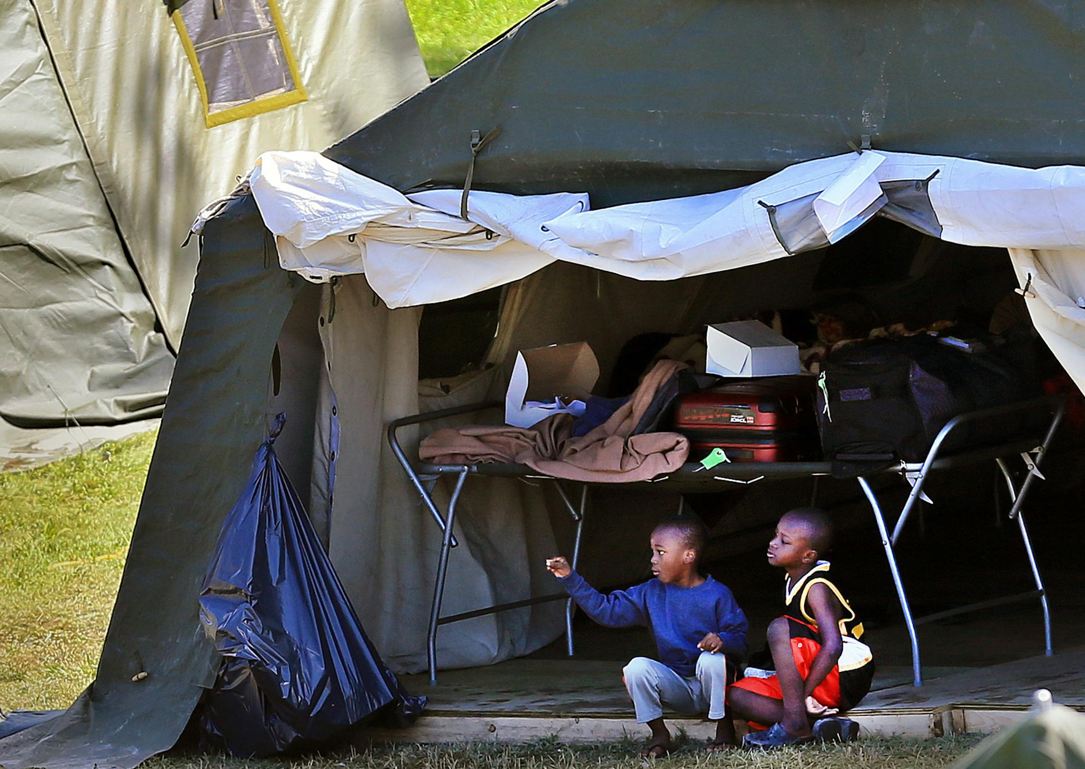 Children sit together at the border migrant camp at St. Bernard de Lacolle. Among the migrants are Haitians who worry that their Temporary Protected Status in the U.S. could soon end under the Trump administration. (Al Diaz/Miami Herald/TNS)