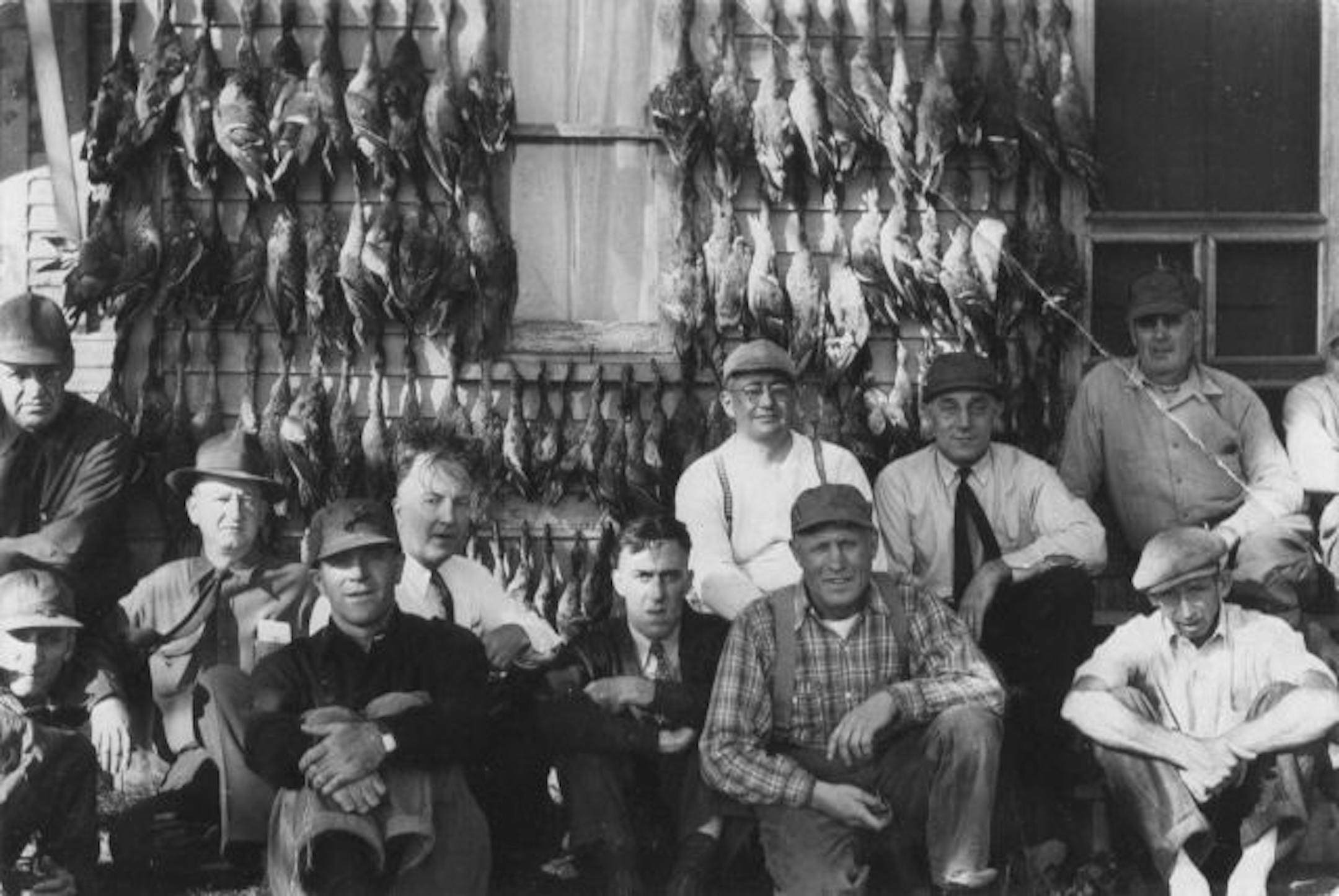 Members of the 3M Gunne Club and inhabitants of the club's Duck Inn with 127 ducks taken on opening weekend, 1943.
