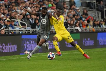 Minnesota United defender Romain Metanire, left, battled the Columbus Crew's David Accam in the first half of a May 18 game at Allianz Field.