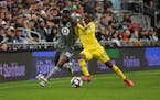 Minnesota United defender Romain Metanire, left, battled the Columbus Crew's David Accam in the first half of a May 18 game at Allianz Field.
