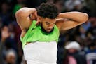 Minnesota Timberwolves center Karl-Anthony Towns wrestles with his jersey after losing to the Denver Nuggets at a NBA basketball game Saturday, Oct. 3