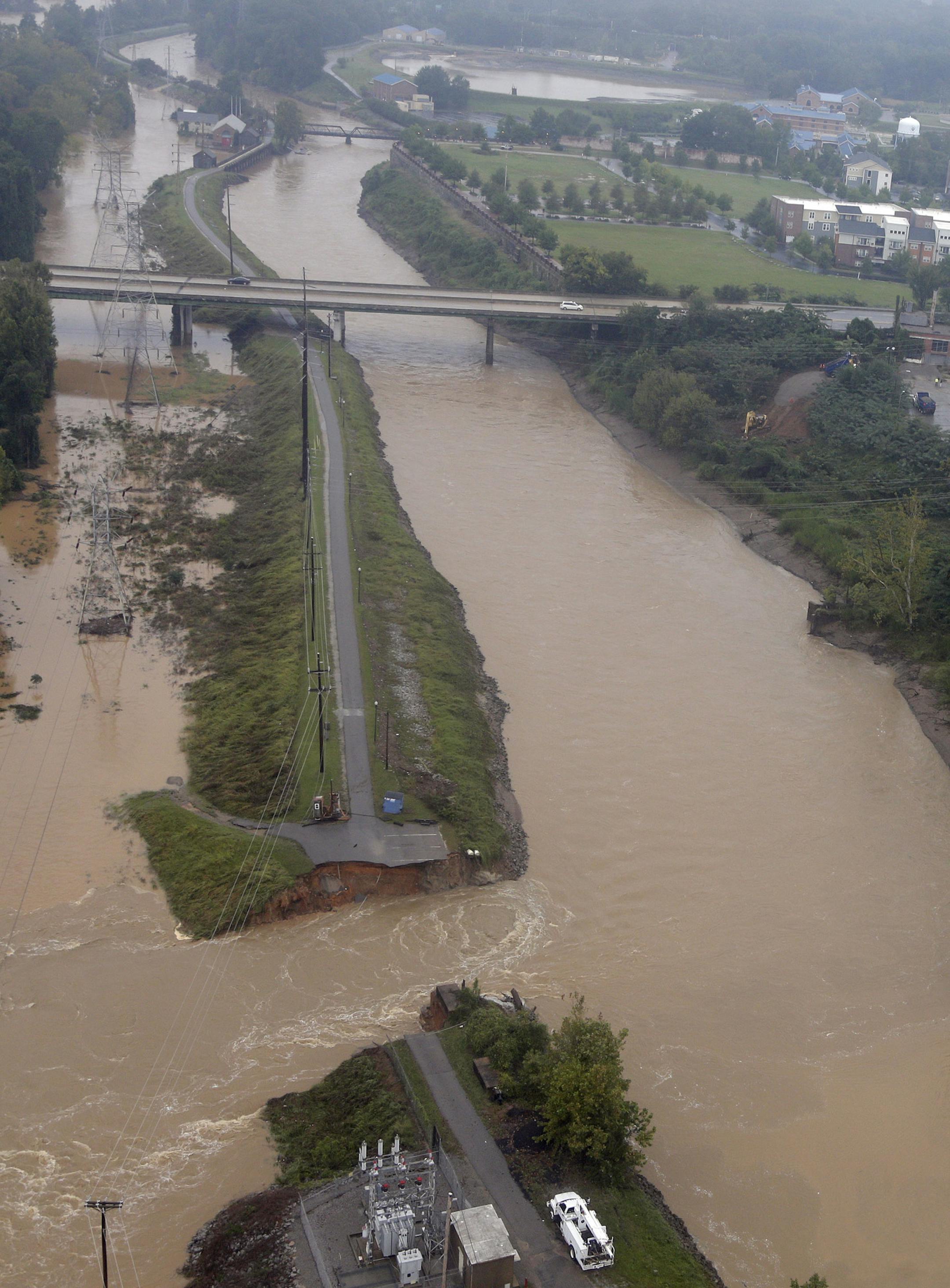 This Oct. 5, 2015 aerial photo shows the breach in the Columbia Canal near the Columbia Water Treatment plant in Columbia, S.C., Monday, Oct. 5, 2015. The storm caused a canal that serves as the area’s main source of drinking water for about half of the Columbia water system’s 375,000 customers has collapsed in two places. Officials are scrambling to build a rock dam to plug the holes. (AP Photo/Chuck Burton)