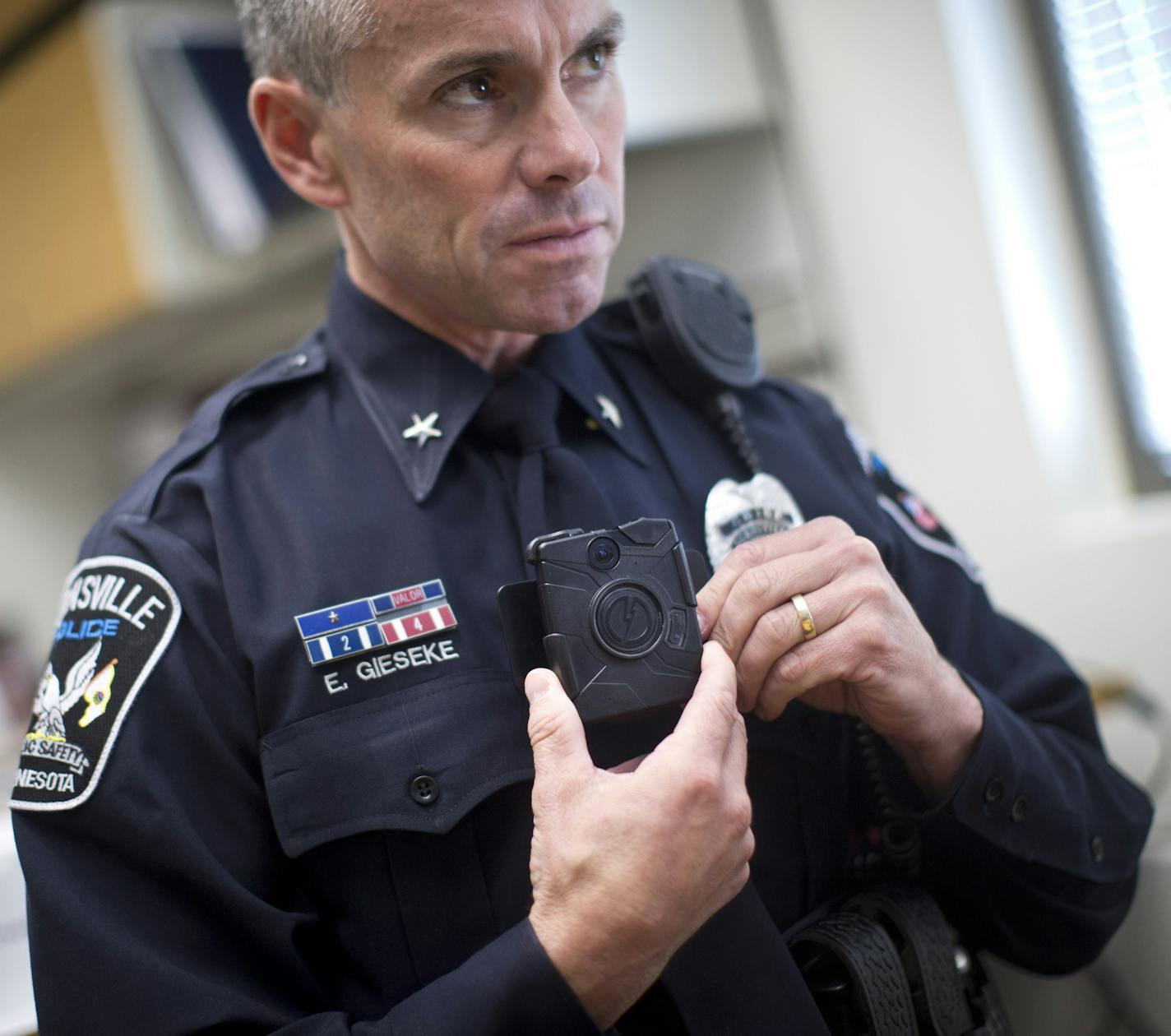 Chest-mounted recorder: Burnsville Police Chief Eric Gieseke showed how an officer wears a chest-style body camera. This is the third year the department has used cameras worn by officers.