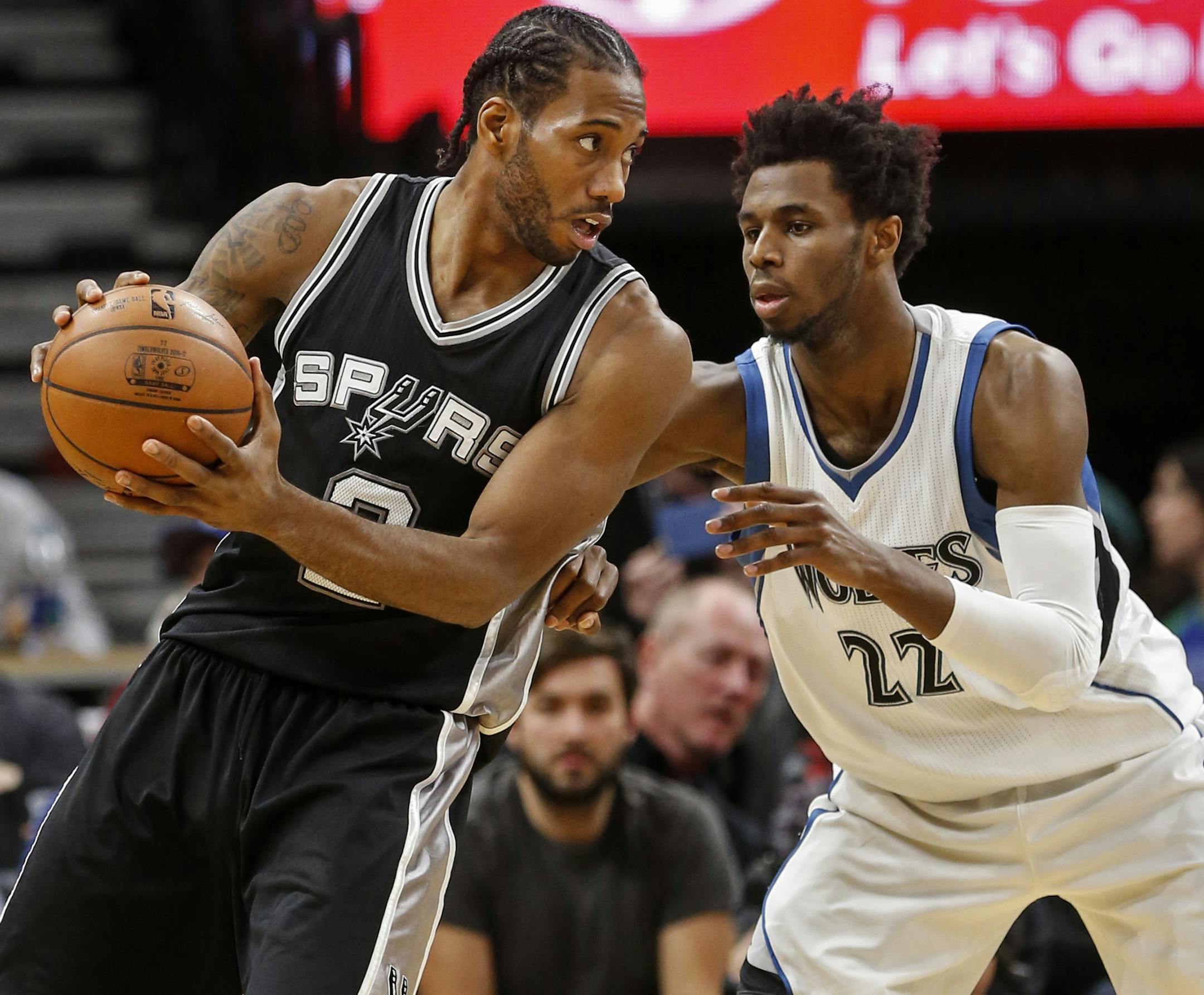 San Antonio Spurs forward Kawhi Leonard (2) works against Minnesota Timberwolves forward Andrew Wiggins (22) in the second half of an NBA basketball game, Tuesday, Dec. 6, 2016, in Minneapolis. The Spurs won 105-91. (AP Photo/Bruce Kluckhohn)