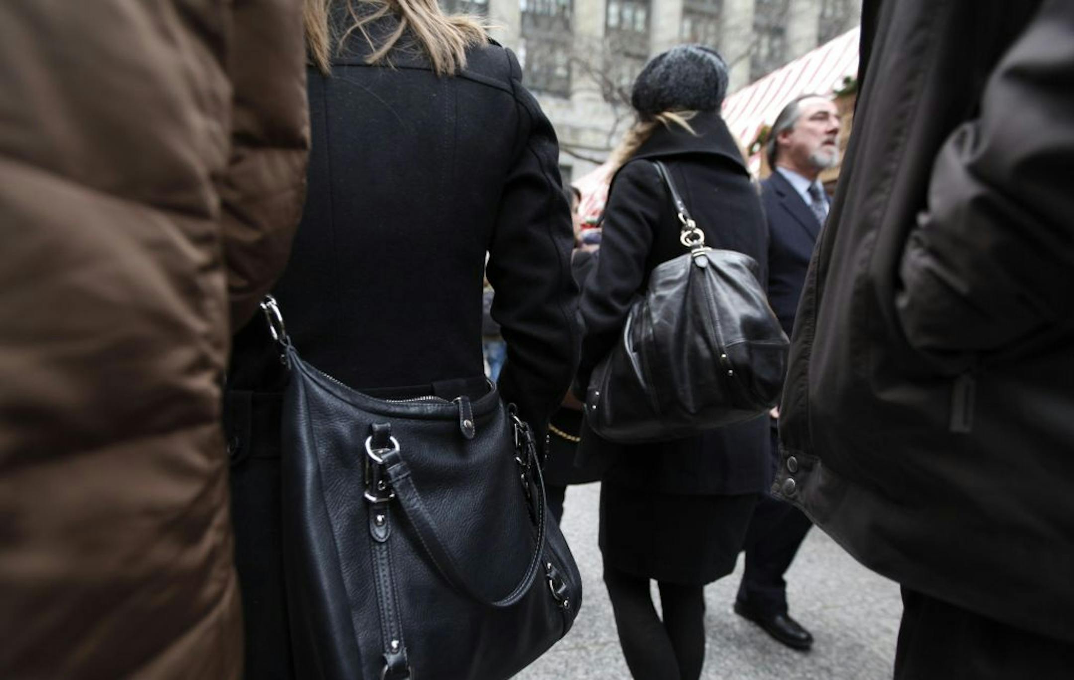 Shoppers walk through a crowd with their purses and bags exposed. Chicago police are waging an offensive against an ancient criminal craft that picks up among shopper and travelers each holiday season.