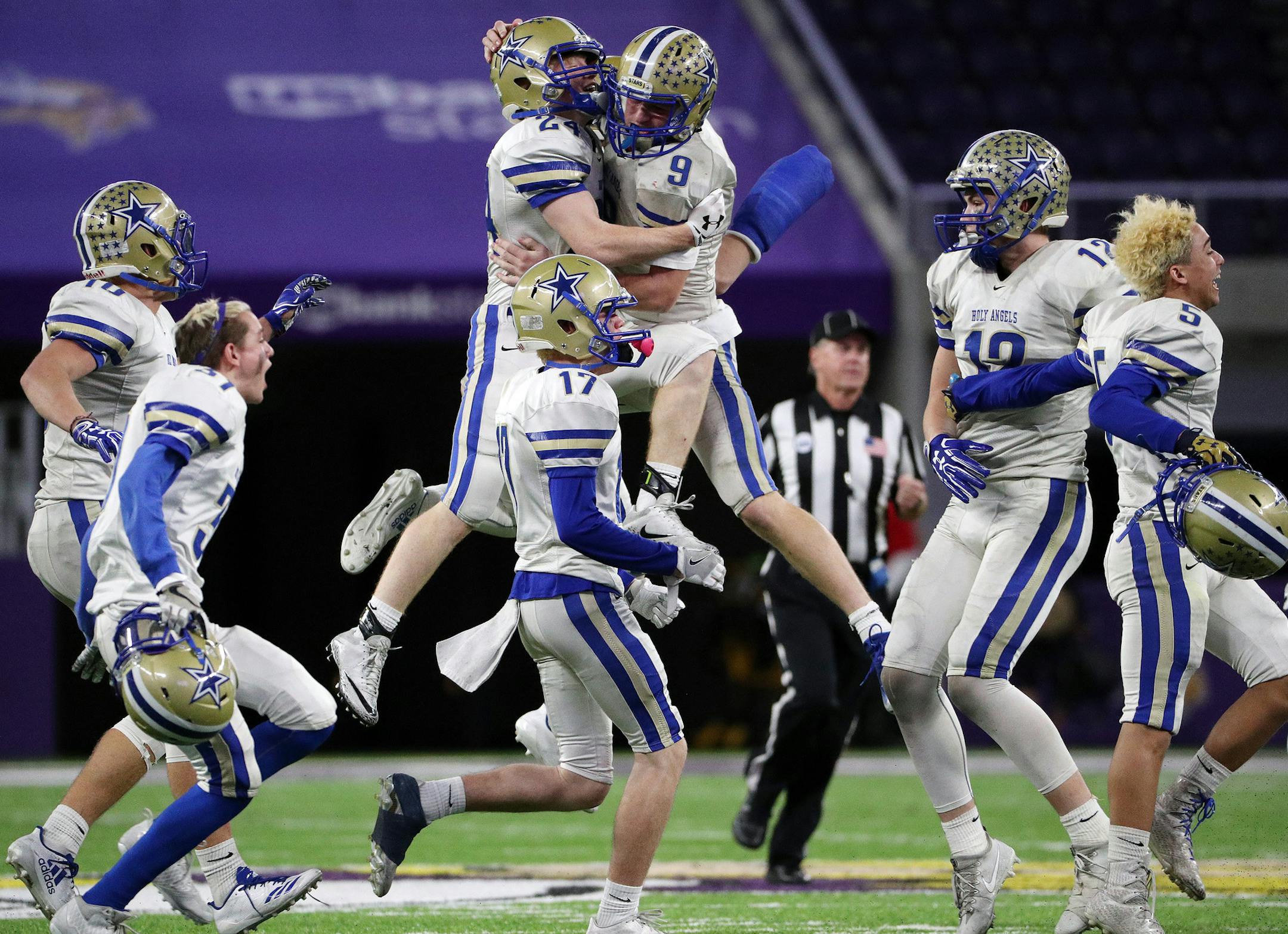 Academy of Holy Angels quarterback Joseph Heimbold (9) celebrated on the field with wide receiver Mason Wolf (24) after defeating Cloquet High School. ] ANTHONY SOUFFLE ï anthony.souffle@startribune.com Game action from a Class 4A championship football game between the Academy of Holy Angels and Cloquet High School Friday, Nov. 24, 2017 at U.S. Bank Stadium in Minneapolis.