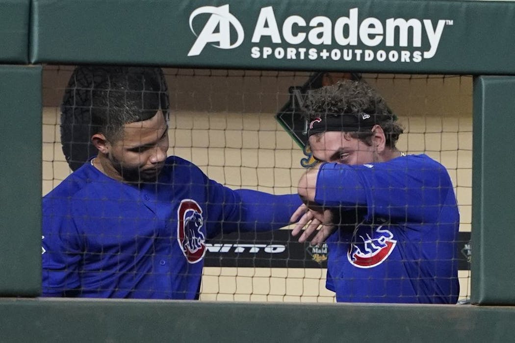Cubs outfielder Albert Almora Jr., right, wipes away tears after checking on a young child who was struck by a foul ball on Wednesday night.
