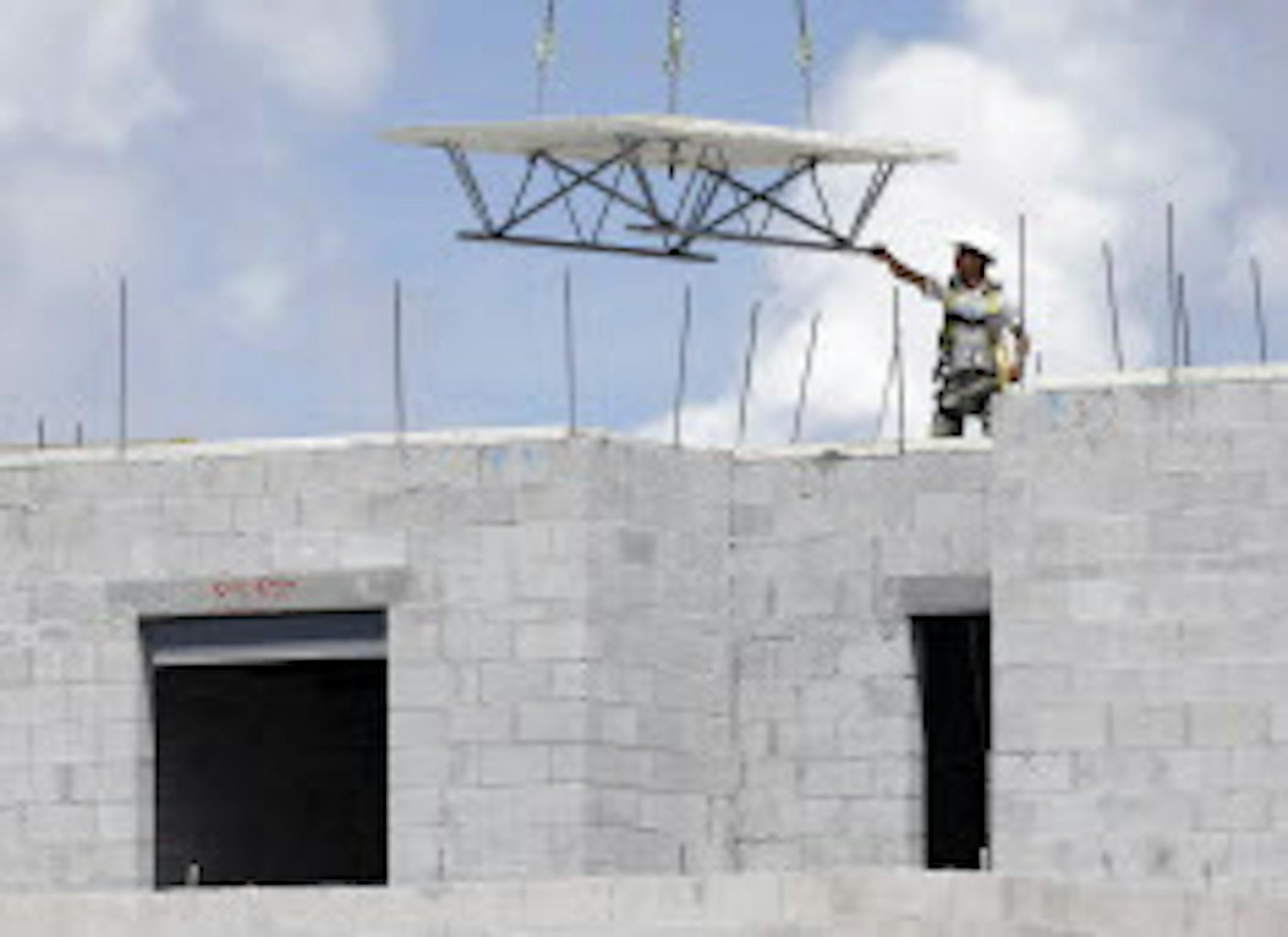 In this Monday, Aug. 17, 2015 photo, a construction worker works on the site of the Landmark community, a group of condos and townhouses built by Lennar Homes, in Doral, Fla. The Commerce Department reports on U.S. construction spending in July on Tuesday, Sept. 1, 2015. (AP Photo/Lynne Sladky)
