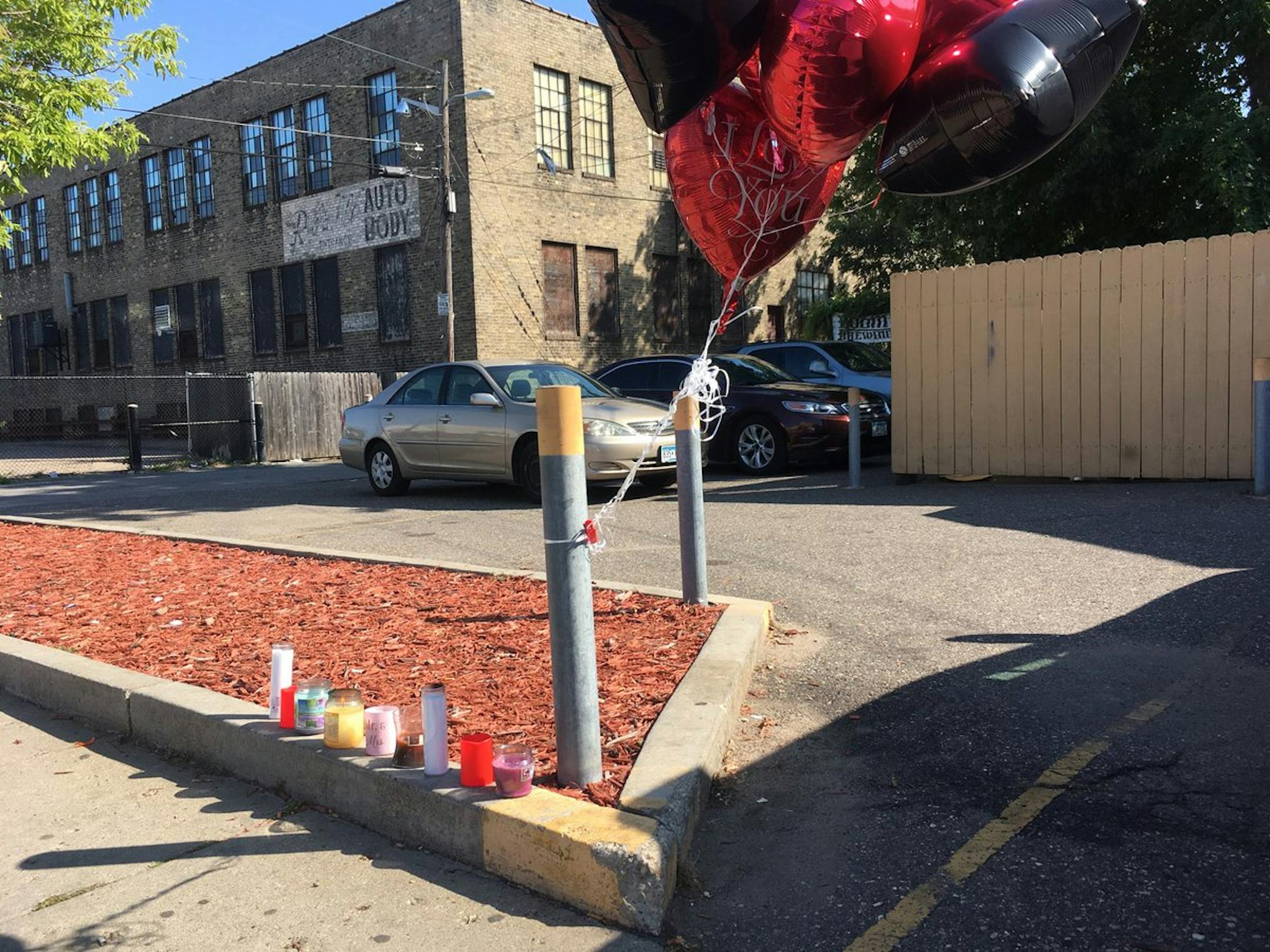 A makeshift memorial was set up in the alley just behind Cliff N Norms bar in Minneapolis, where one man was killed and three were injured by gunfire late Friday.