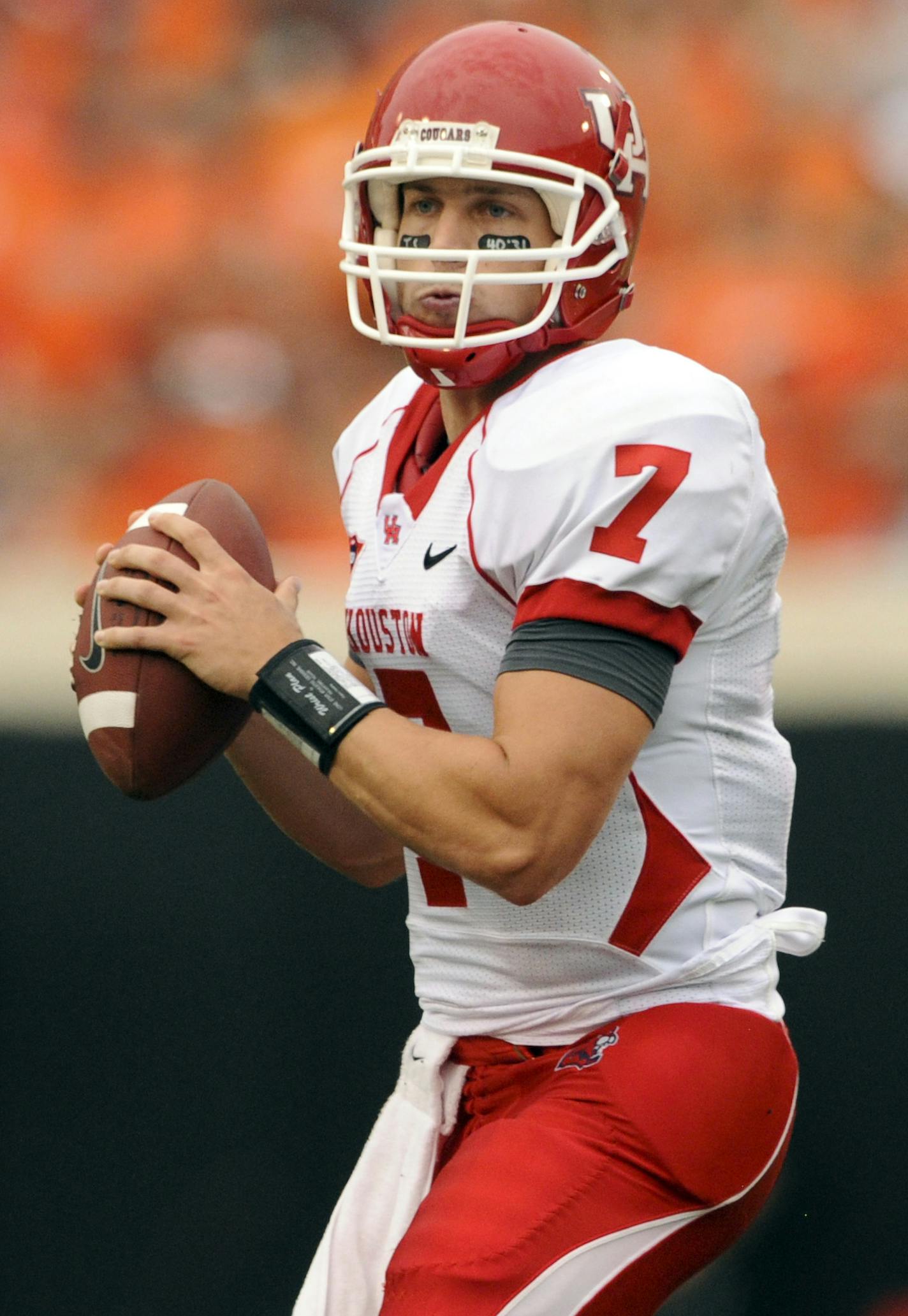 In this photo taken on Saturday, Sept. 12, 2009, Houston quarterback Case Keenum looks down field during the first half of an NCAA college football game against Oklahoma State in Stillwater, Okla. The Cougars busted into the AP top 25 poll by knocking off then-No. 5 Oklahoma State 45-35 and moved up after a bye week in which several ranked teams lost. (AP Photo/Brody Schmidt) ORG XMIT: OKBS101