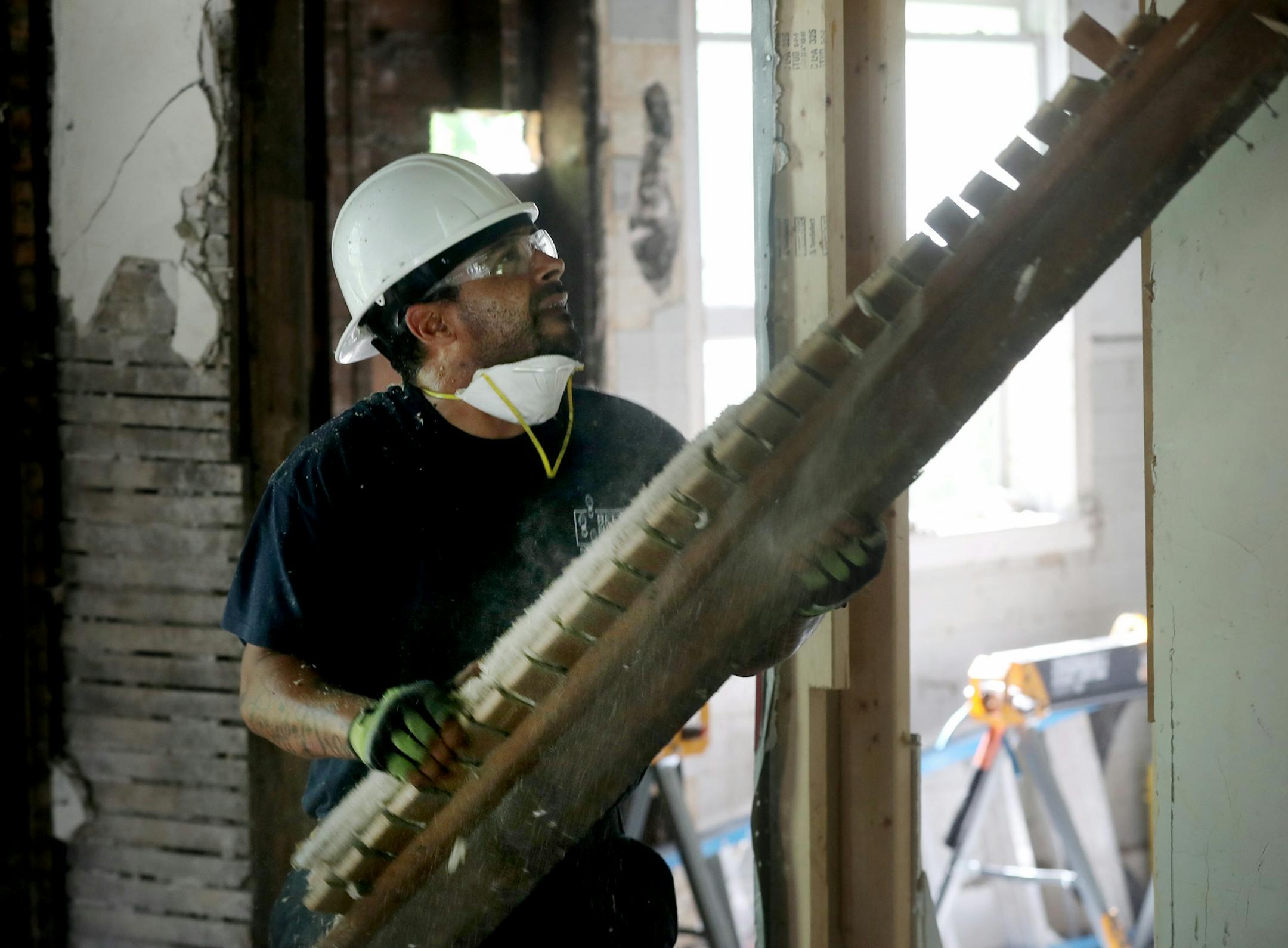 Josh Stewart, crew-chief-in-training for Better Homes Minnesota, a non-profits that assists men in the community in gaining employment while helping protect the environment, removed lumber from a house being disassembled and seen Tuesday, July 18, 2017, in Roseville, MN.