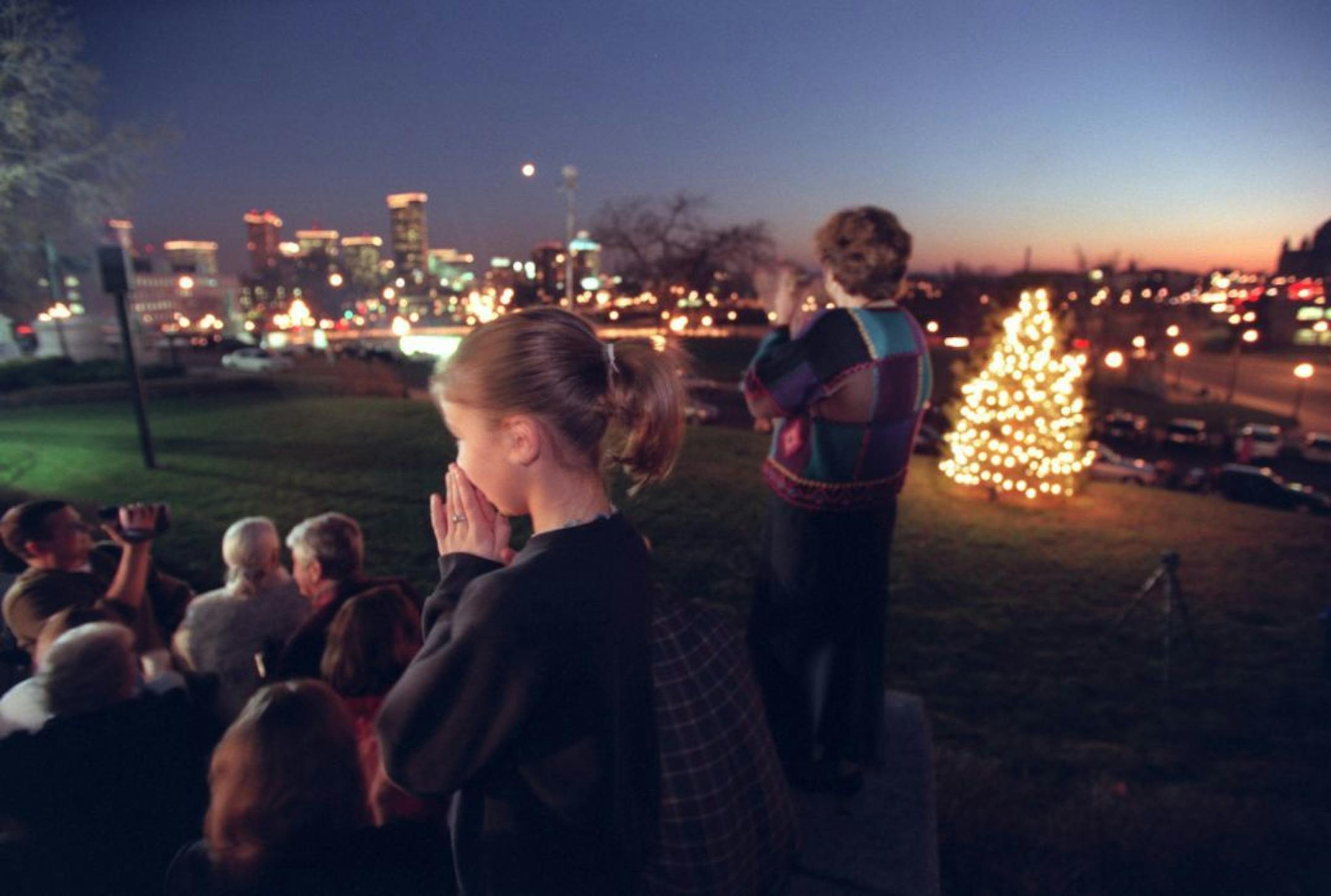 Lt. Gov. Joanne Benson lights the State Capitol Holiday Tree. Following the lighting, the Partners in Praise Girls Choir will sing. -- Kurstin Justen,(CQ) 10 of Brooklyn Park and Janet Leach of St. Paul applaud as the State Capitol Holiday Tree is lit in St. Paul on Thursday evening. The Partners in Praise Girls Choir sang during before the ceremony.