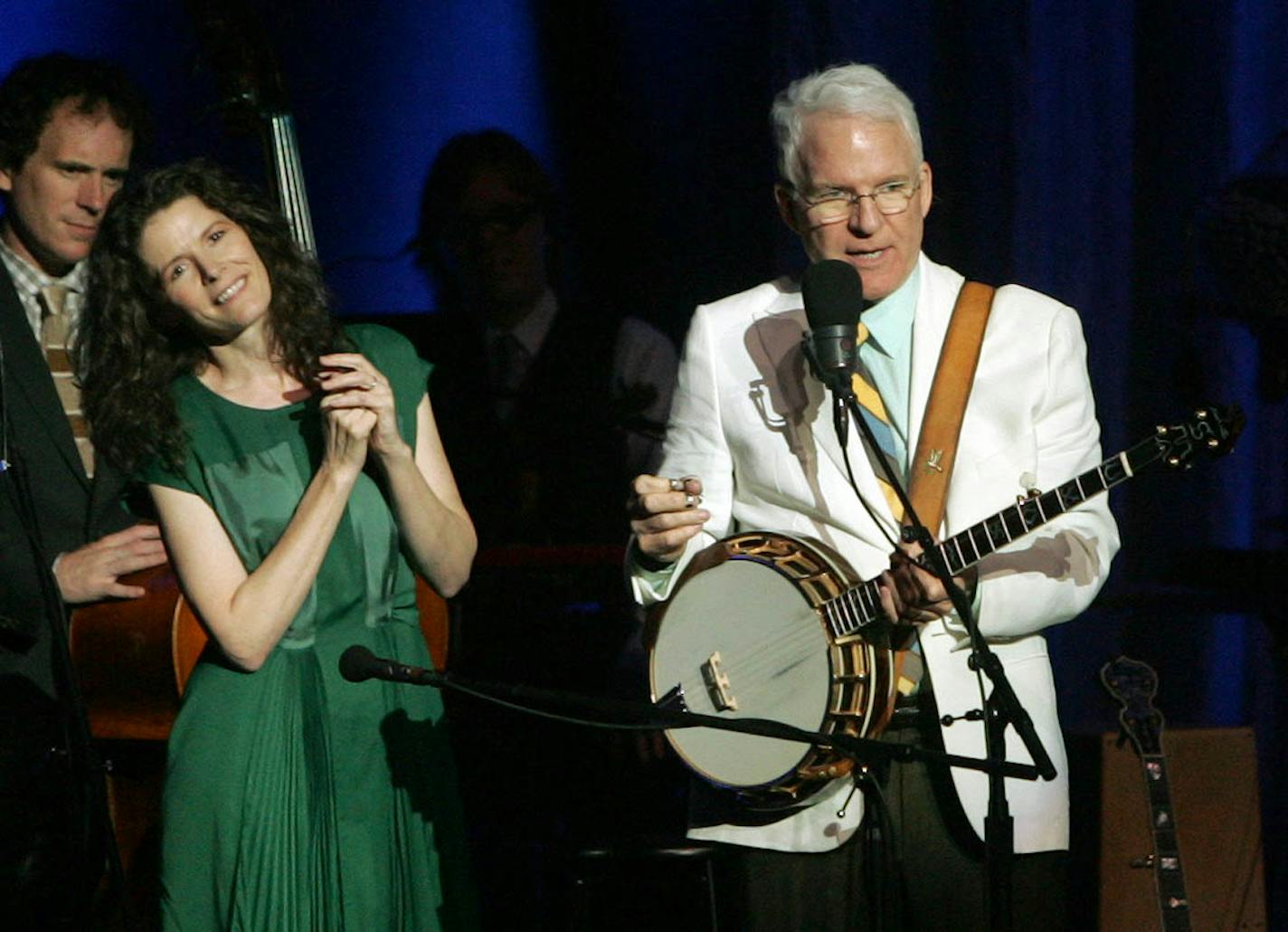 CORRECTS PHOTOGRAPHER'S BYLINE TO DAVE SCHERBENCO INSTEAD OF AL DIAZ - Steve Martin banters with the audience at the FM Kirby Center in Wilkes Barre, Pa. on Tuesday night, July 2, 2013 as singer Edie Brickell listens in. Martin is on tour with his Bluegrass band The Steep Canyon Rangers. (AP Photo/The Citizens' Voice, Dave Scherbenco) ORG XMIT: MIN2013071612591741