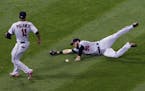Minnesota Twins left fielder Robbie Grossman, right, cannot make the play on a single by Chicago White Sox's Melky Cabrera as shortstop Jorge Polanco,