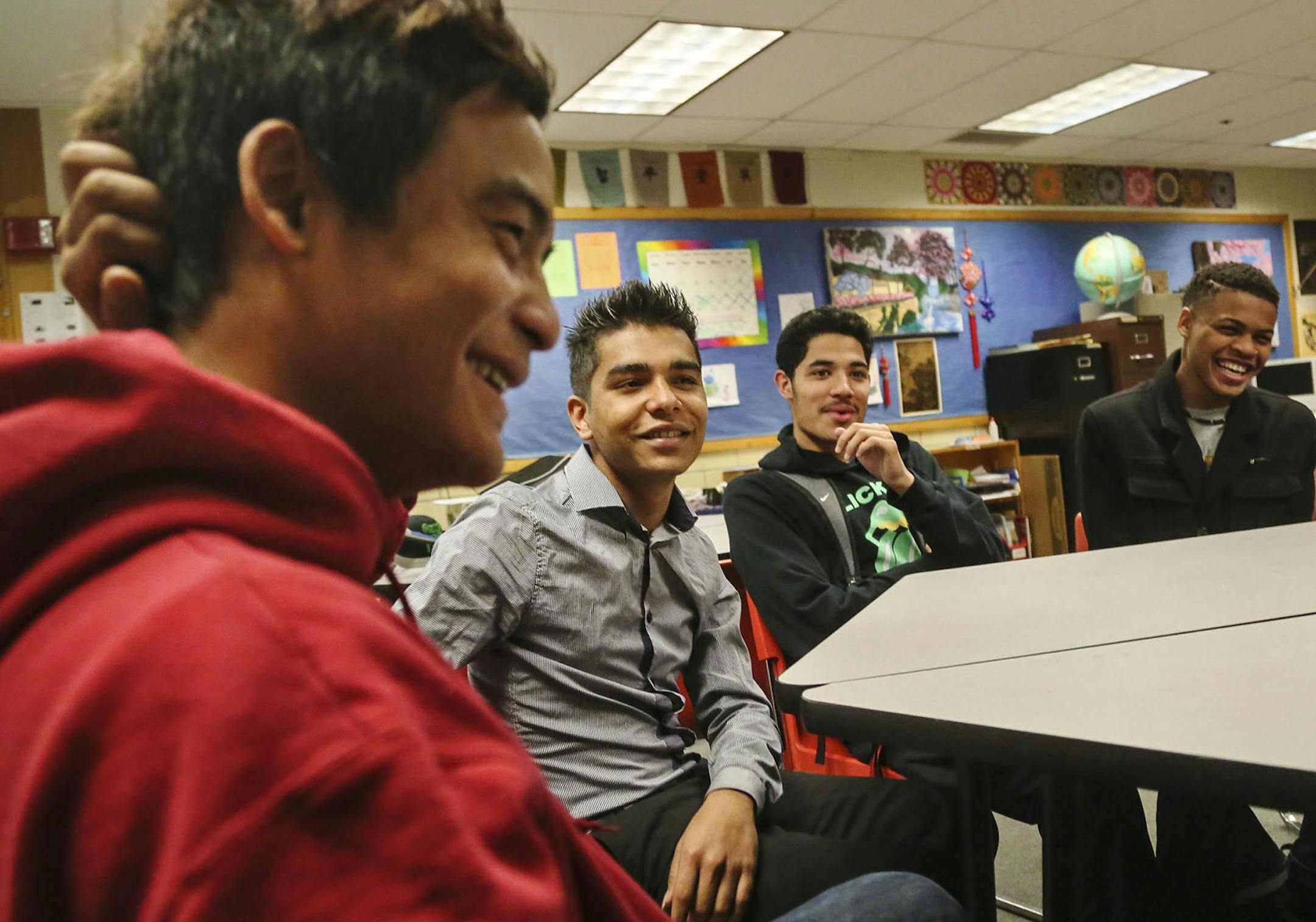 The Multiculural Leaders group, formerly the African American Karen Alliance, meets at Roseville High School three times a month and met Wednesday, Nov. 19, 2014, in Roseville, MN. Here, group members and Roseville High students, left to right, Taw Ler Moo (who is Karen), Keshab Gautum, Erick Minero Jr., and Benjamin Carter Jr. all laughed as they talked about how lack of communication had previously caused conflict, sometimes fighting among them.](DAVID JOLES/STARTRIBUNE)djoles@startribune The