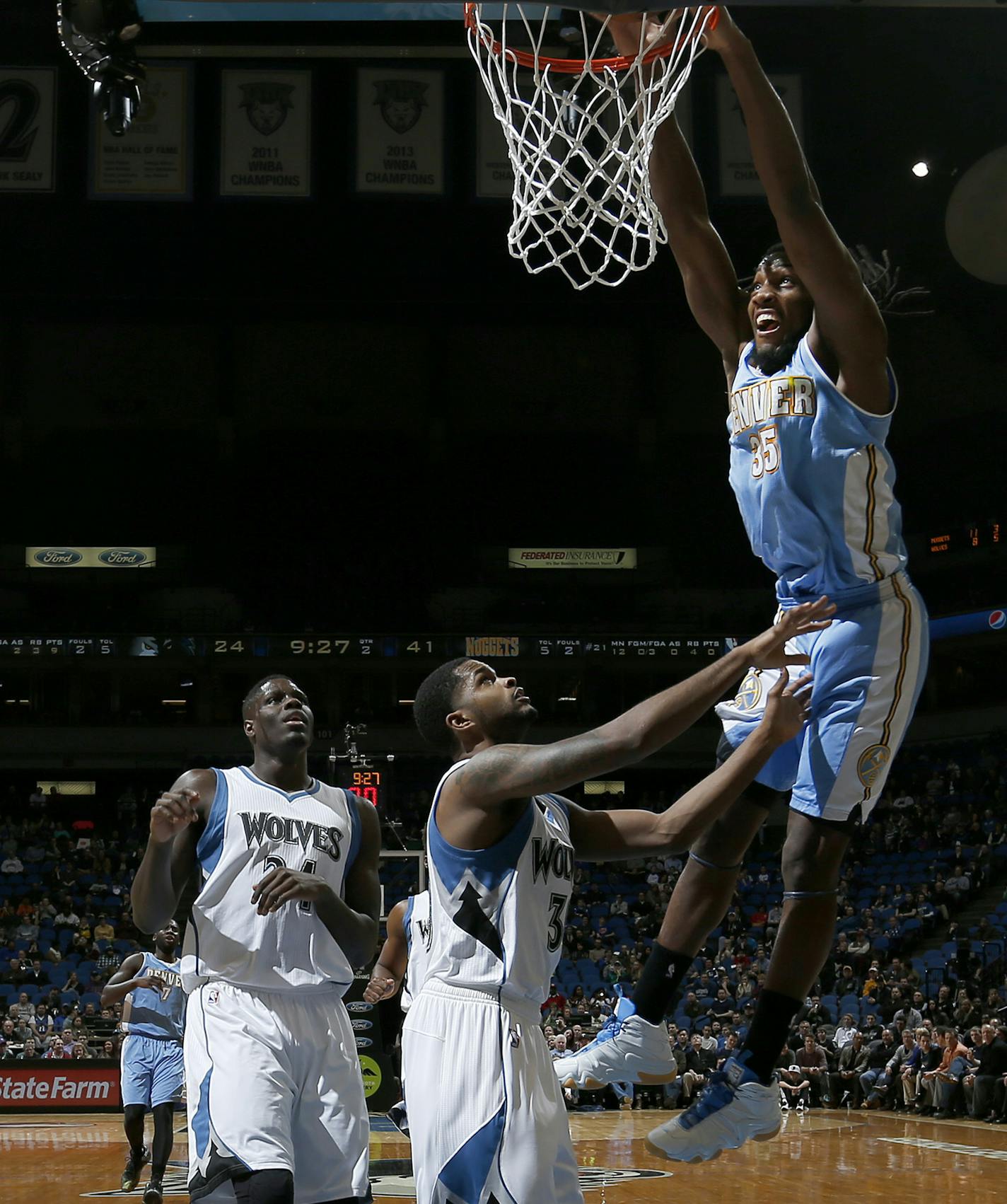 Kenneth Faried (35) dunked the ball while being defended by Troy Daniels (30) in second quarter. ] CARLOS GONZALEZ cgonzalez@startribune.com, January 5, 2015, Minneapolis, Minn., Target Center, NBA, Minnesota Timberwolves vs. Denver Nuggets