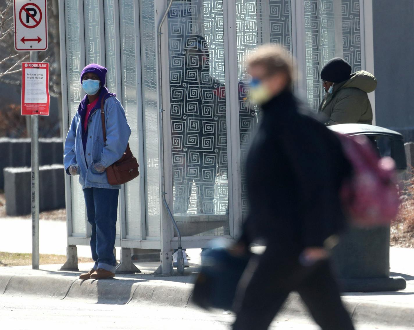 Some people are wearing face masks in public, as seen Thursday near HCMC in Minneapolis.