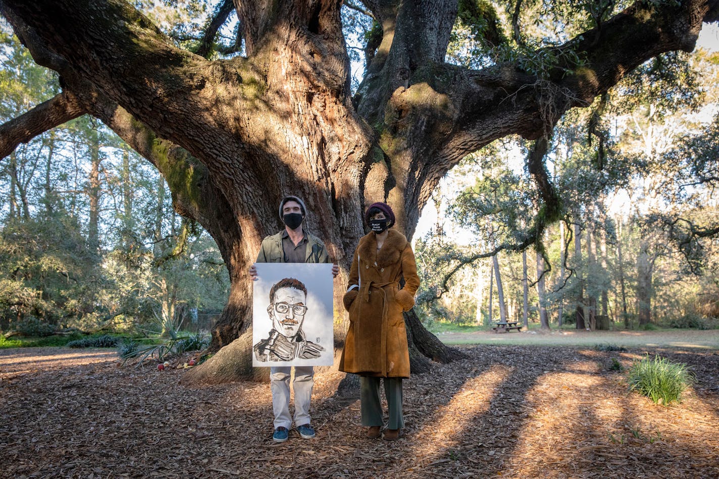 Eric Champagne, 34, holding a portrait he made of Daniel Baker, is shown with Jack Fox Keen, 30, in Tallahassee's Lichgate Park on Jan. 29. MUST CREDIT: Photo for The Washington Post by Charlotte Kesl