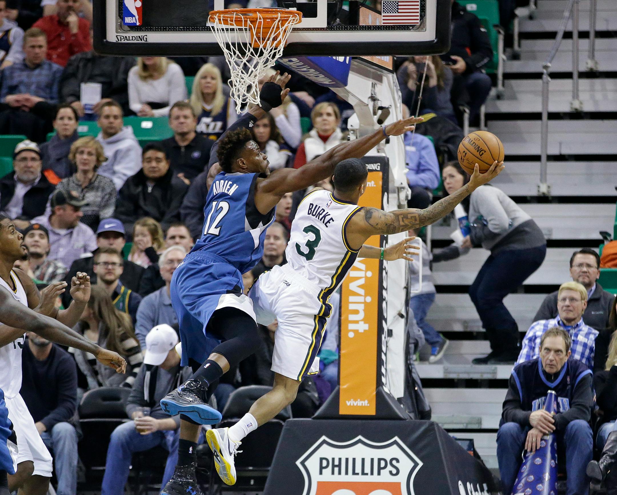 Utah Jazz guard Trey Burke shot up and around Timberwolves forward Jeff Adrien (12) in the second quarter Tuesday night in Salt Lake City.