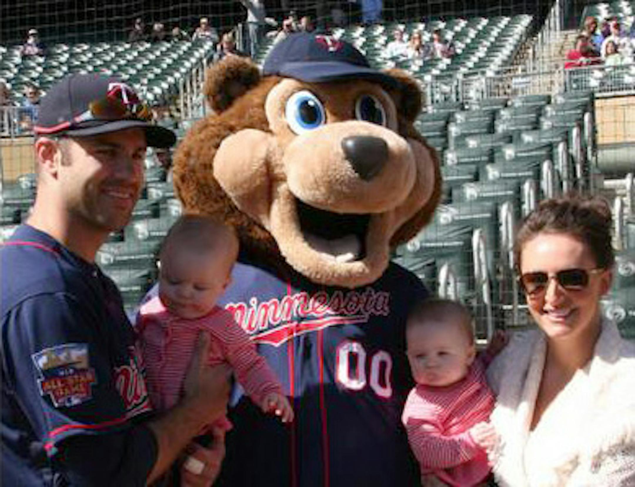 Joe Mauer joined by his wife Maddie & daughters Emily and Maren on the field as he accepted his Silver Slugger Award on April 10, 2014.