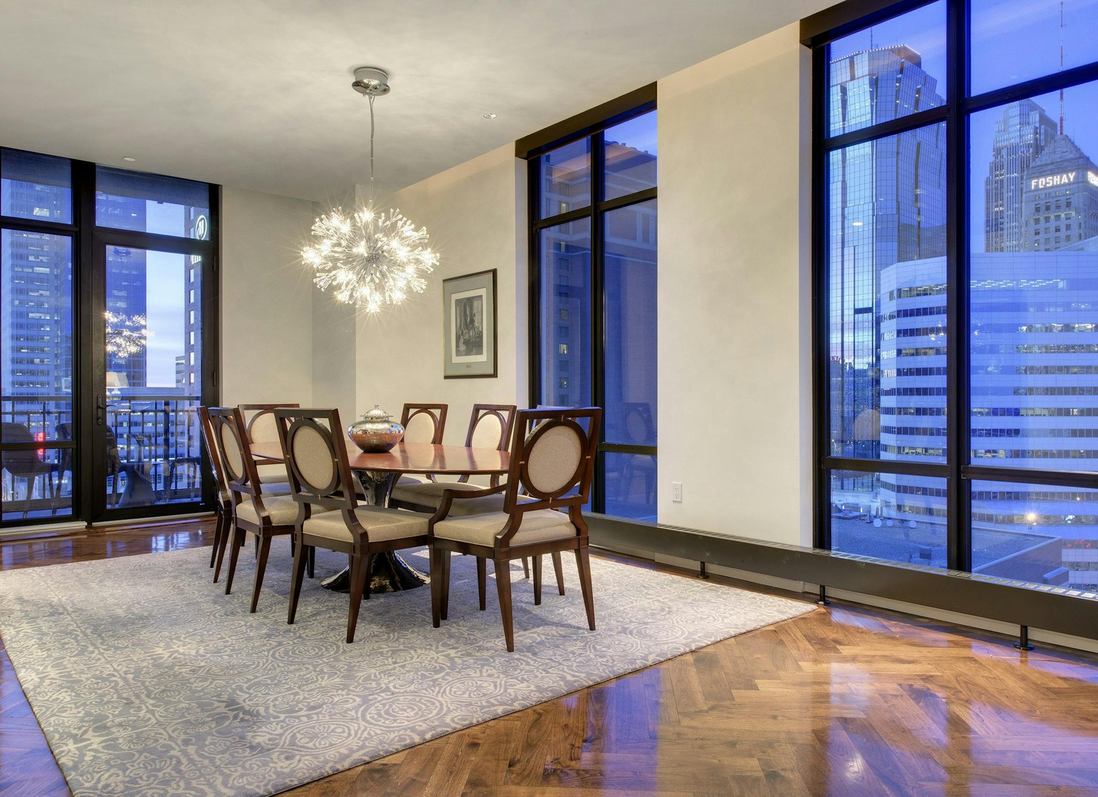 The formal dining room has floor-to-ceiling glass views of downtown Minneapolis skyscrapers.