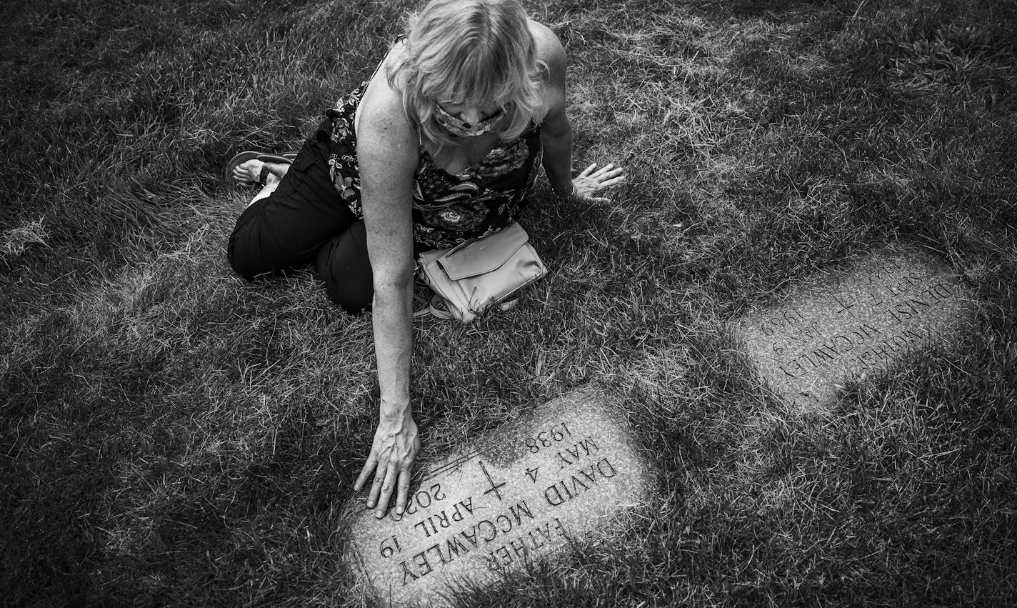 "I will never again assume that a place that calls itself a 'care center' will be committed to caring for its patients," said Laura McCawley, as she swept grass of the gravestone of her 81-year-old father, David McCawley, who died of the virus months after moving into North Ridge.] RICHARD TSONG-TAATARII • richard.tsong-taatarii@startribune.com